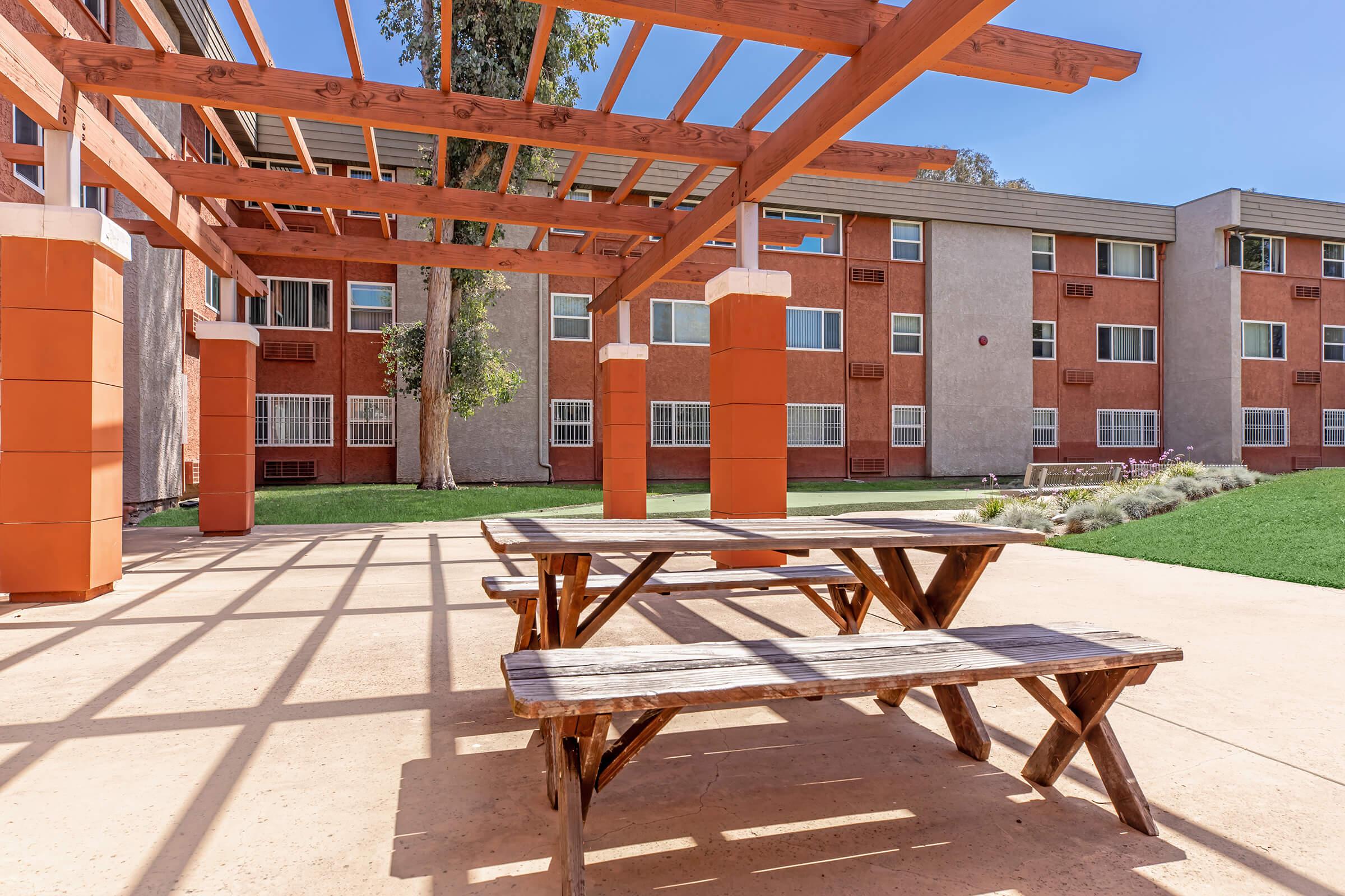 a wooden bench sitting in front of a building