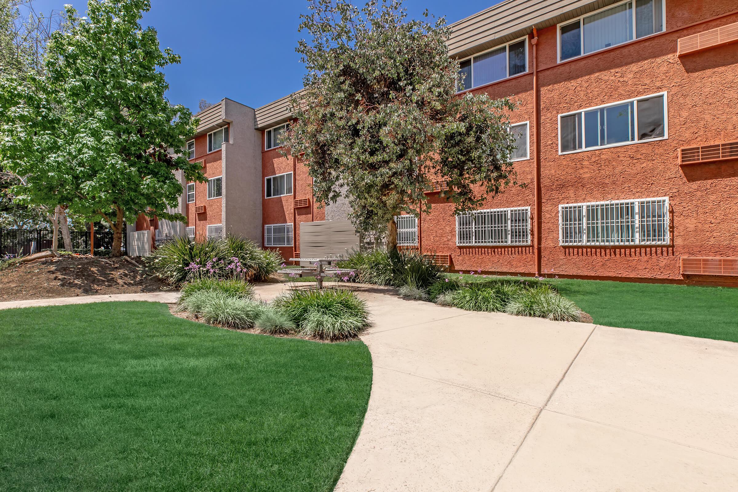 a large lawn in front of a brick building