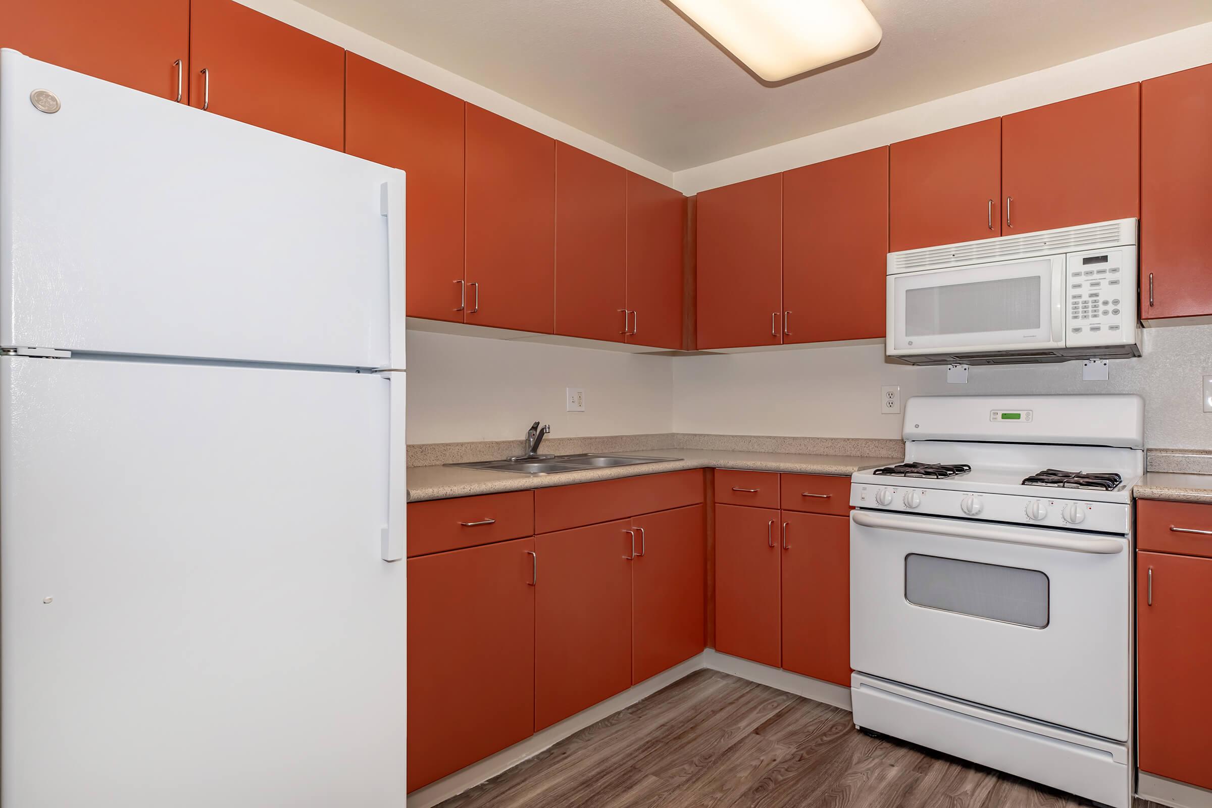 a kitchen with a stove and a refrigerator