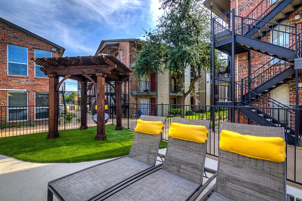 lounge chairs next to a pergola