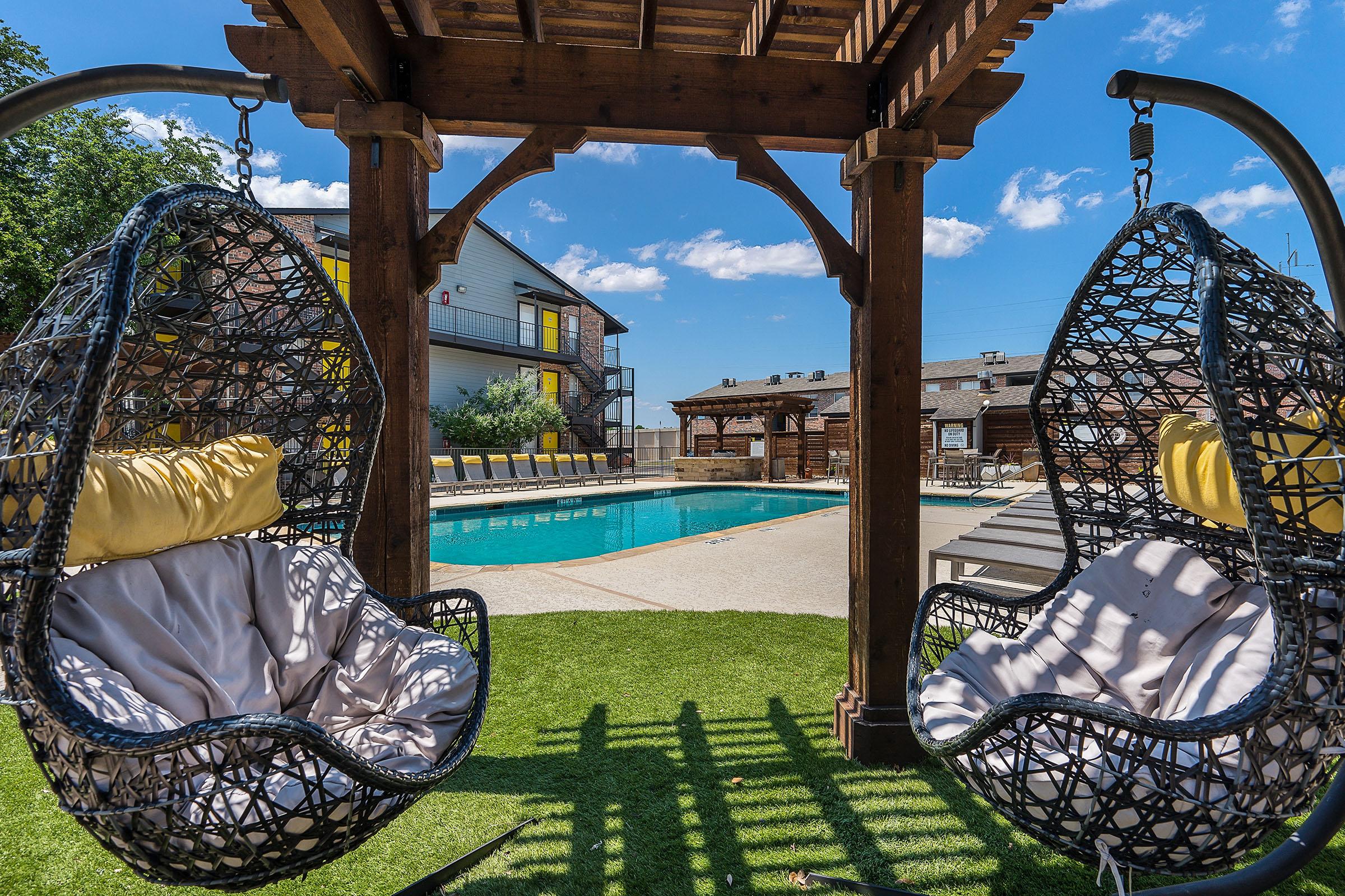 swinging chairs under a pergola