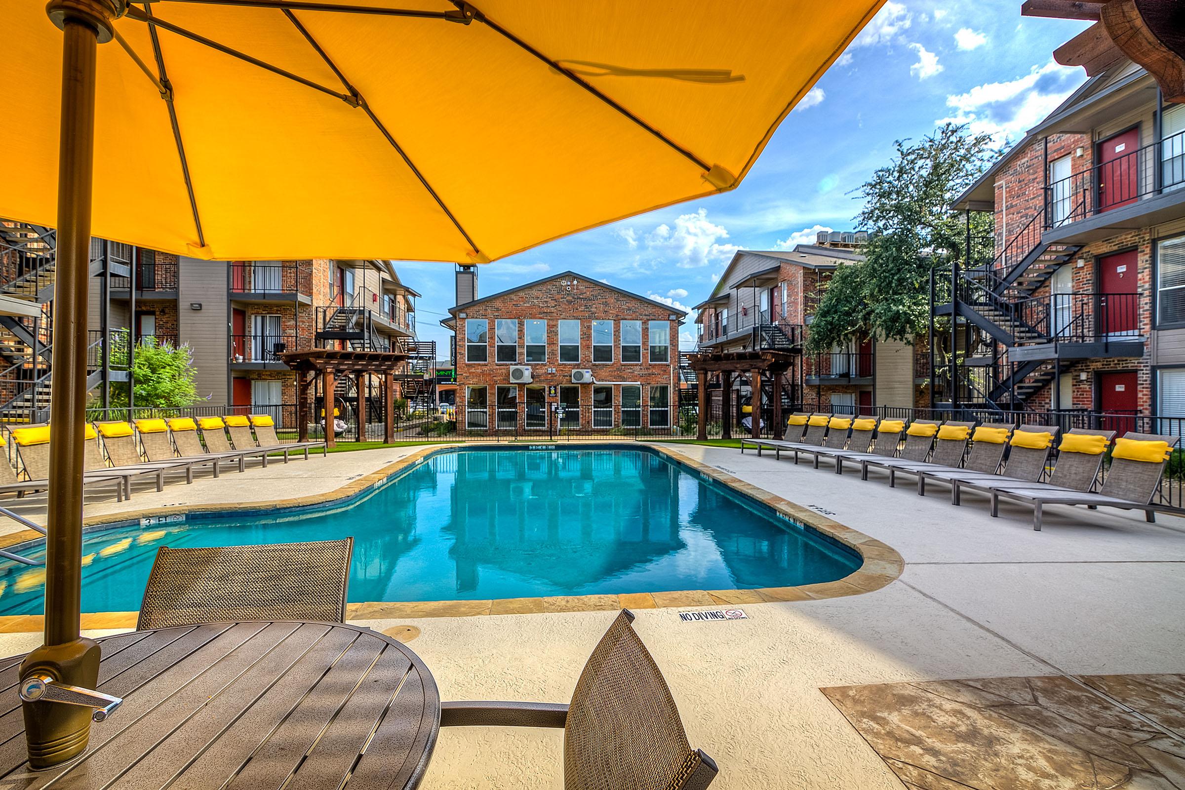 The Edge community pool with a yellow umbrella