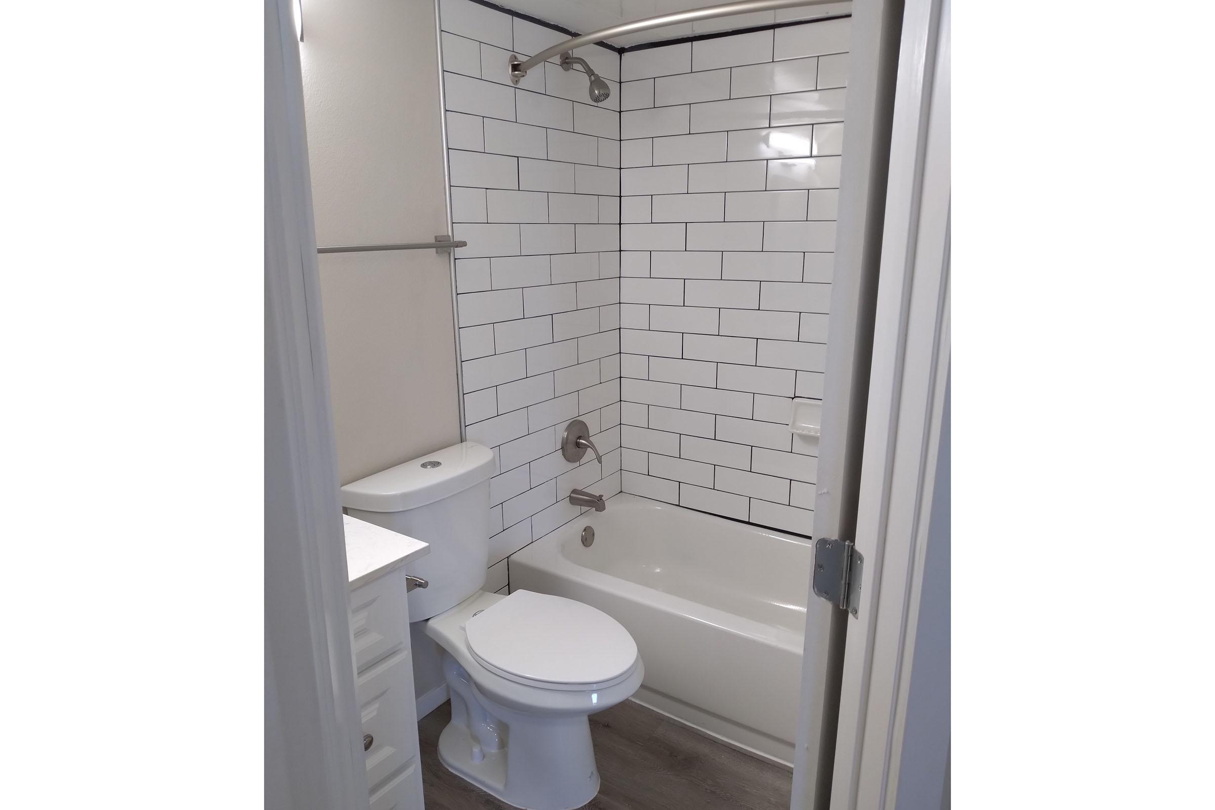 vacant bathroom with white tiles