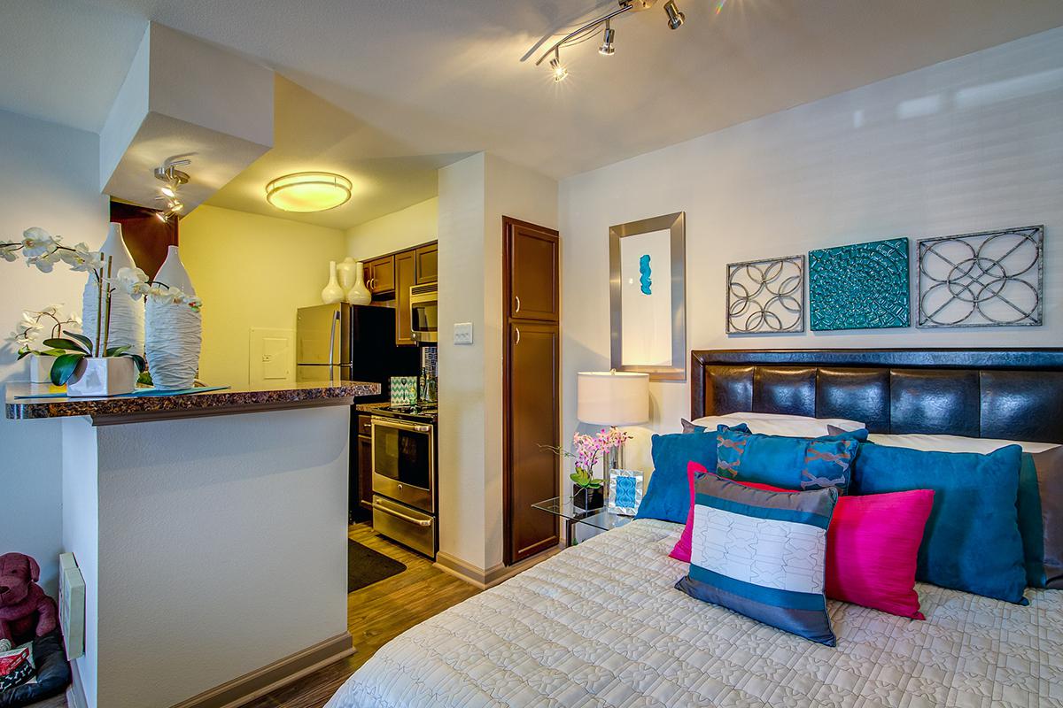 bedroom and kitchen with wooden floors