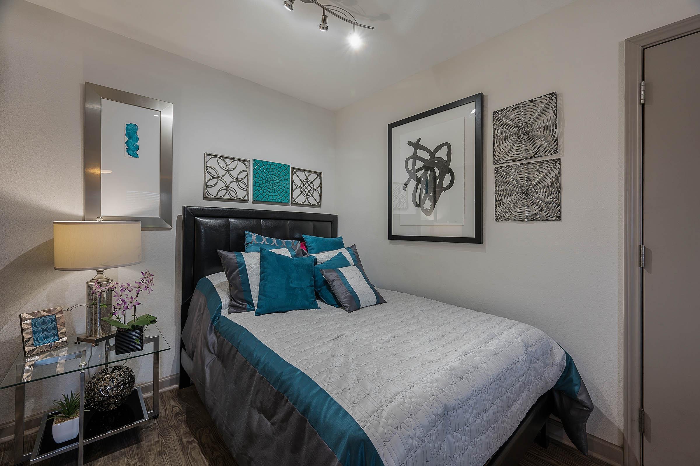 a furnished bedroom with wooden floors