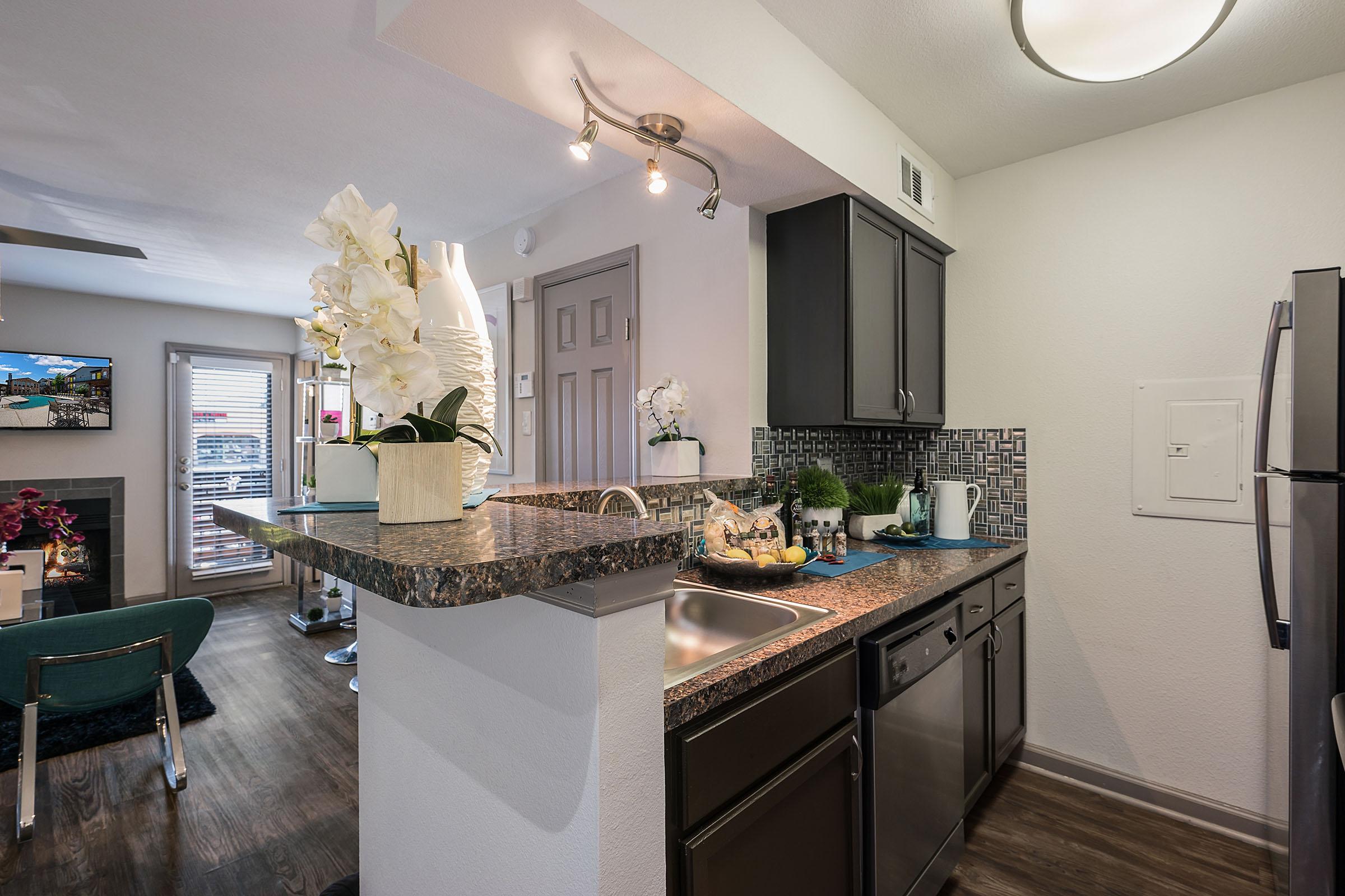 a furnished kitchen with wooden floors