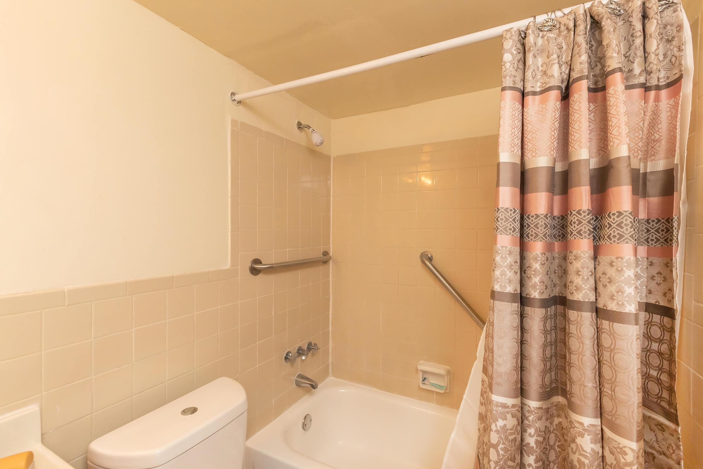 a white sink sitting next to a shower