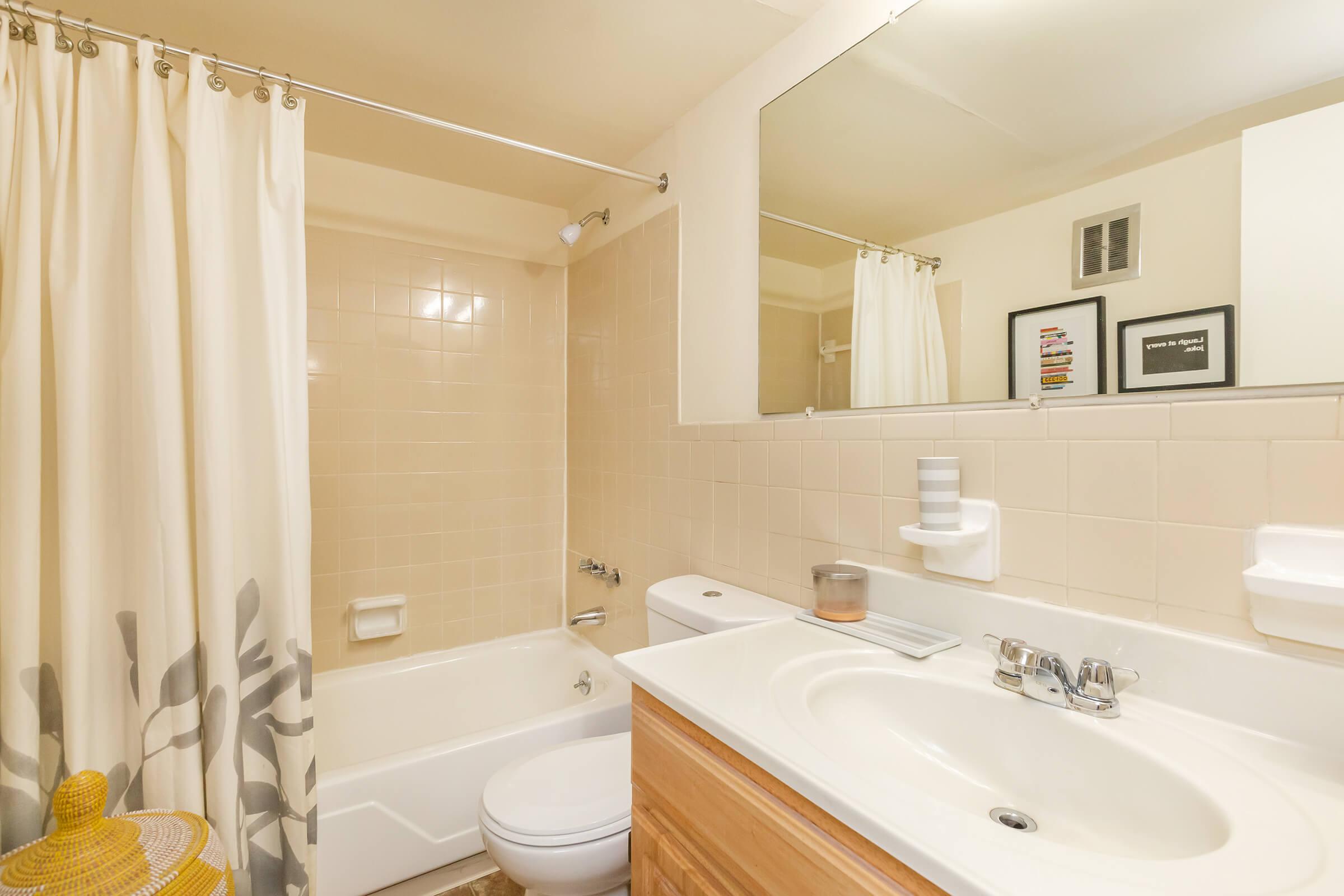 a large white tub sitting next to a sink