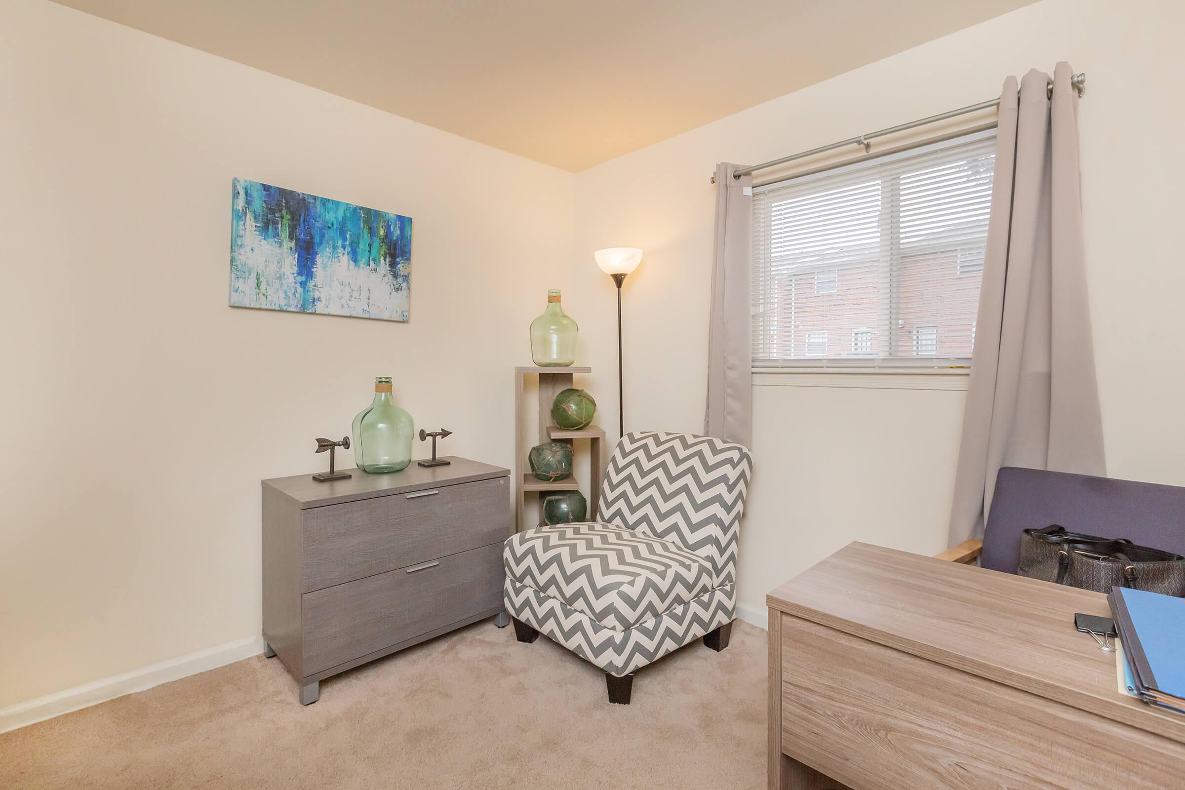 a bedroom with a bed and desk in a room