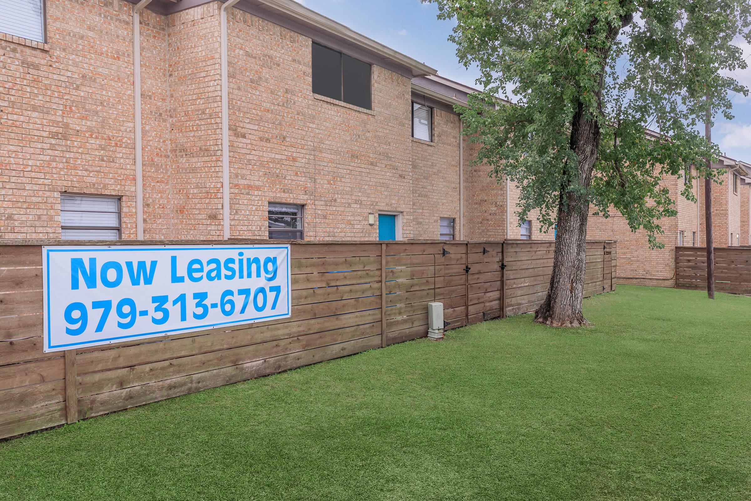 a sign in front of a brick building