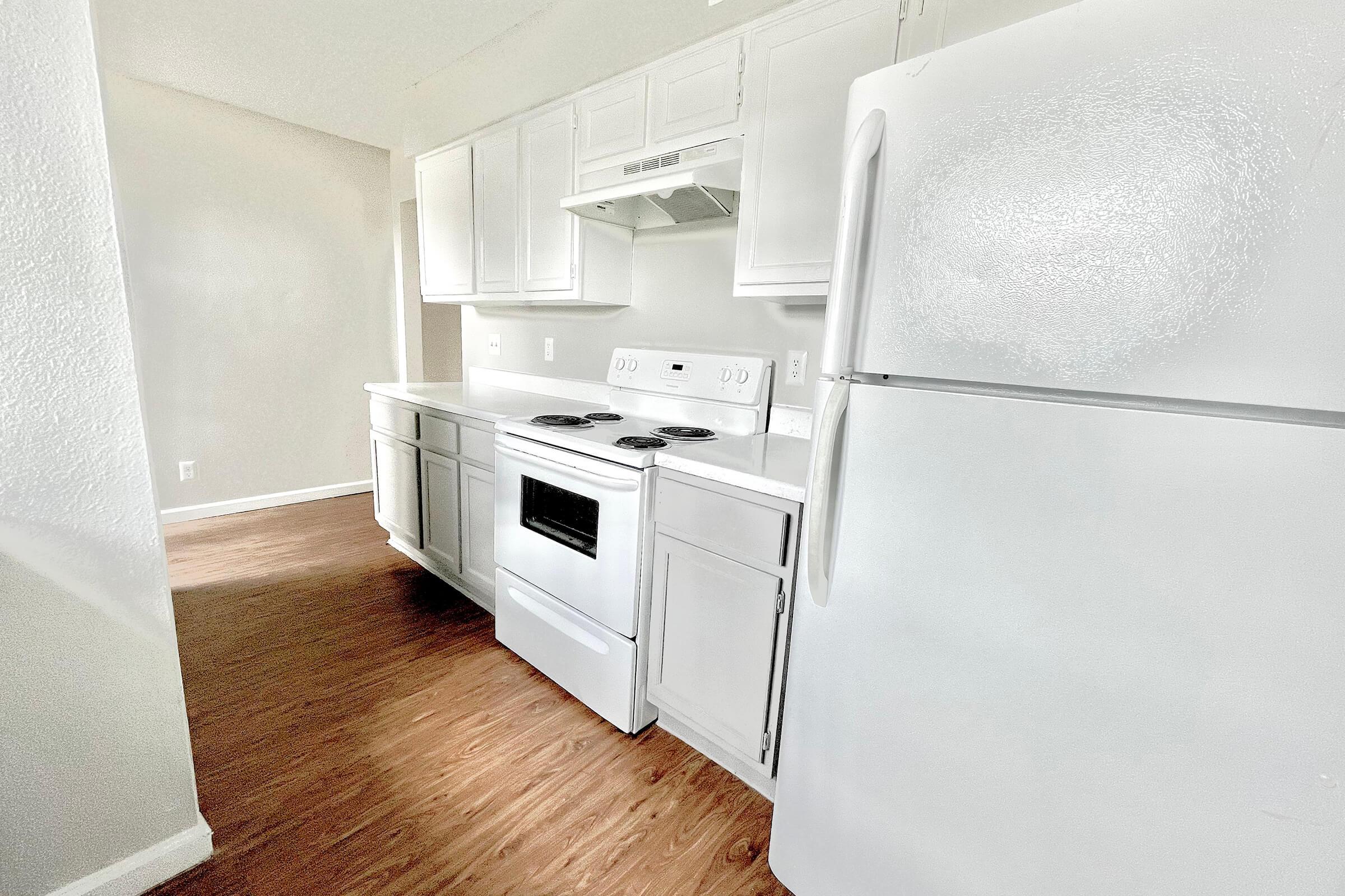 a kitchen with a stove top oven sitting inside of a refrigerator