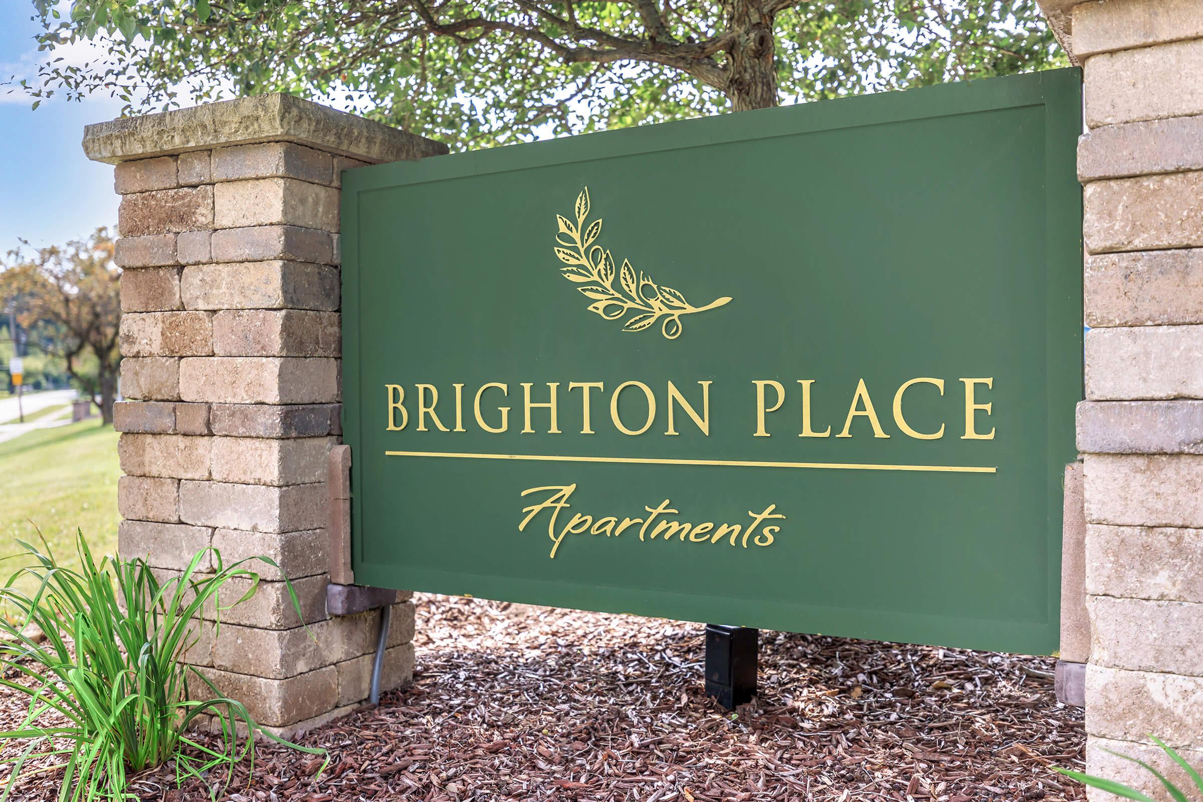 a sign in front of a brick building