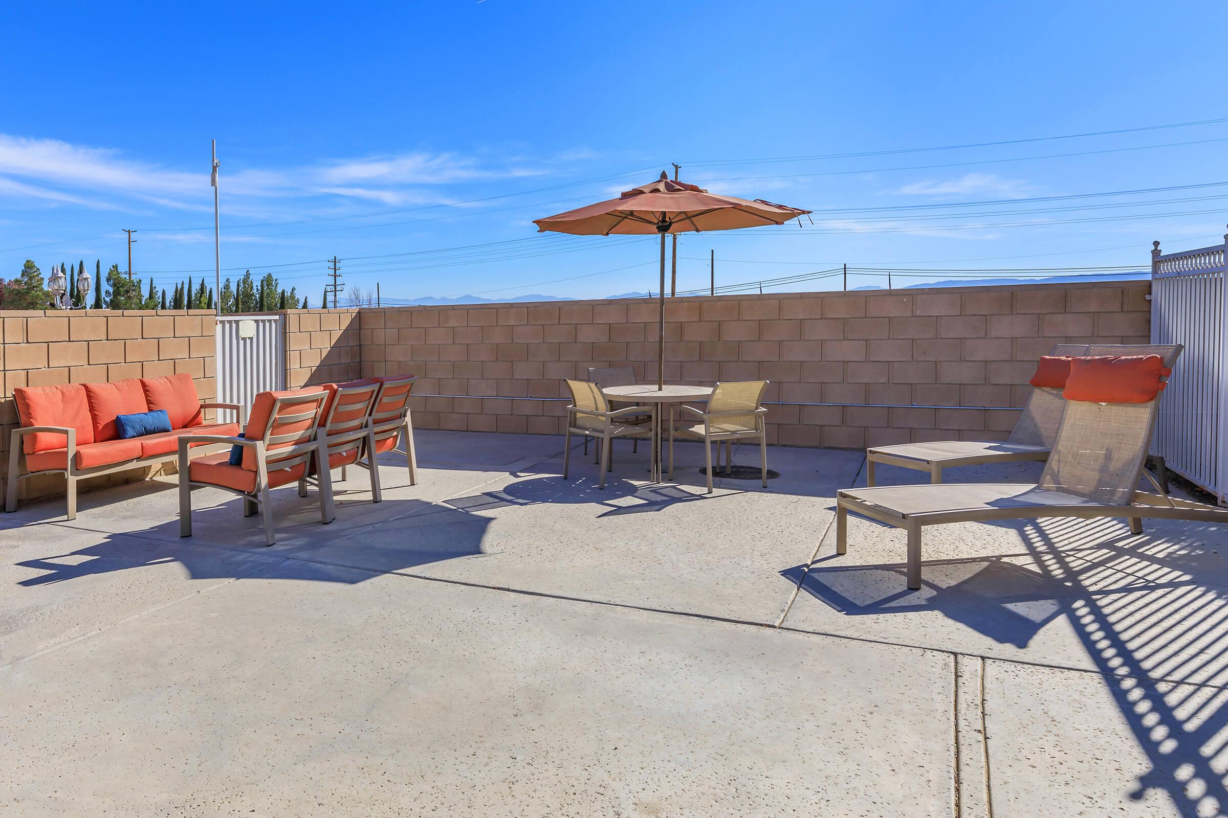 a group of lawn chairs sitting on top of a sandy beach