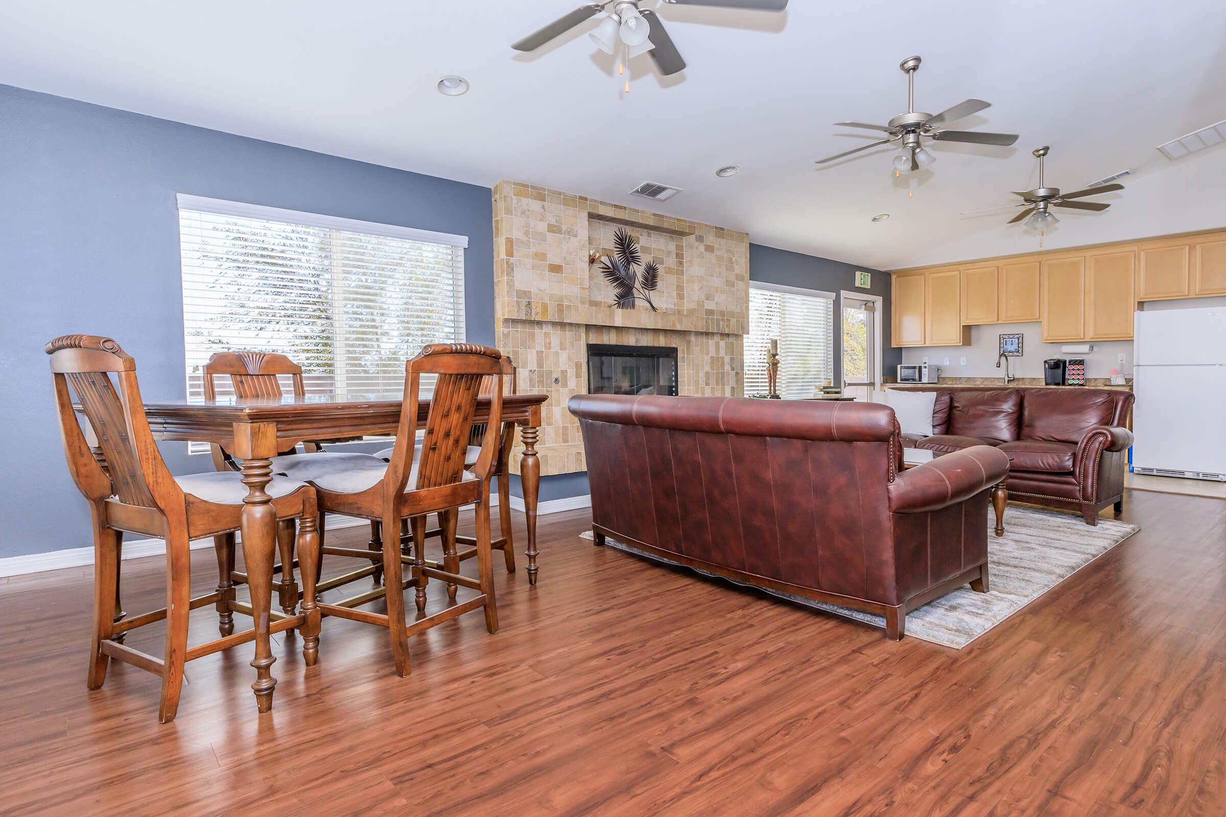 a room filled with furniture on top of a wooden floor