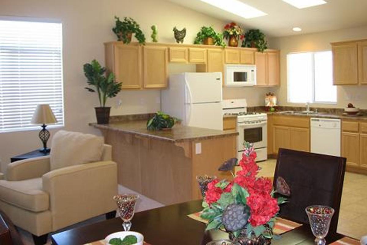 a living room filled with furniture and vase of flowers on a table