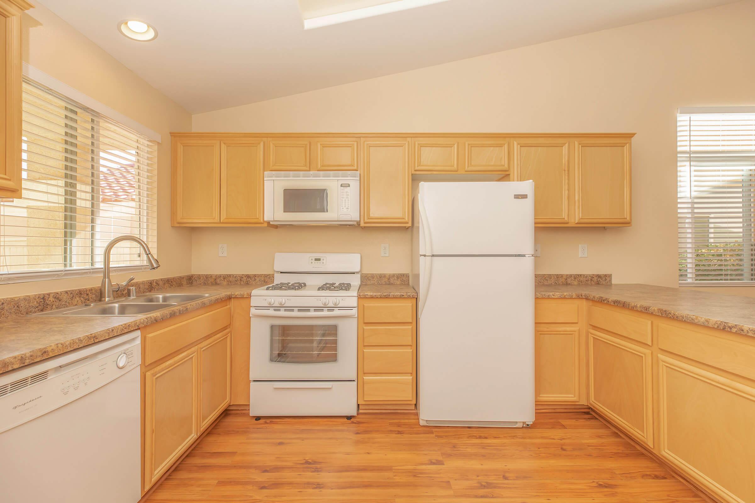 a kitchen with wooden cabinets and a microwave