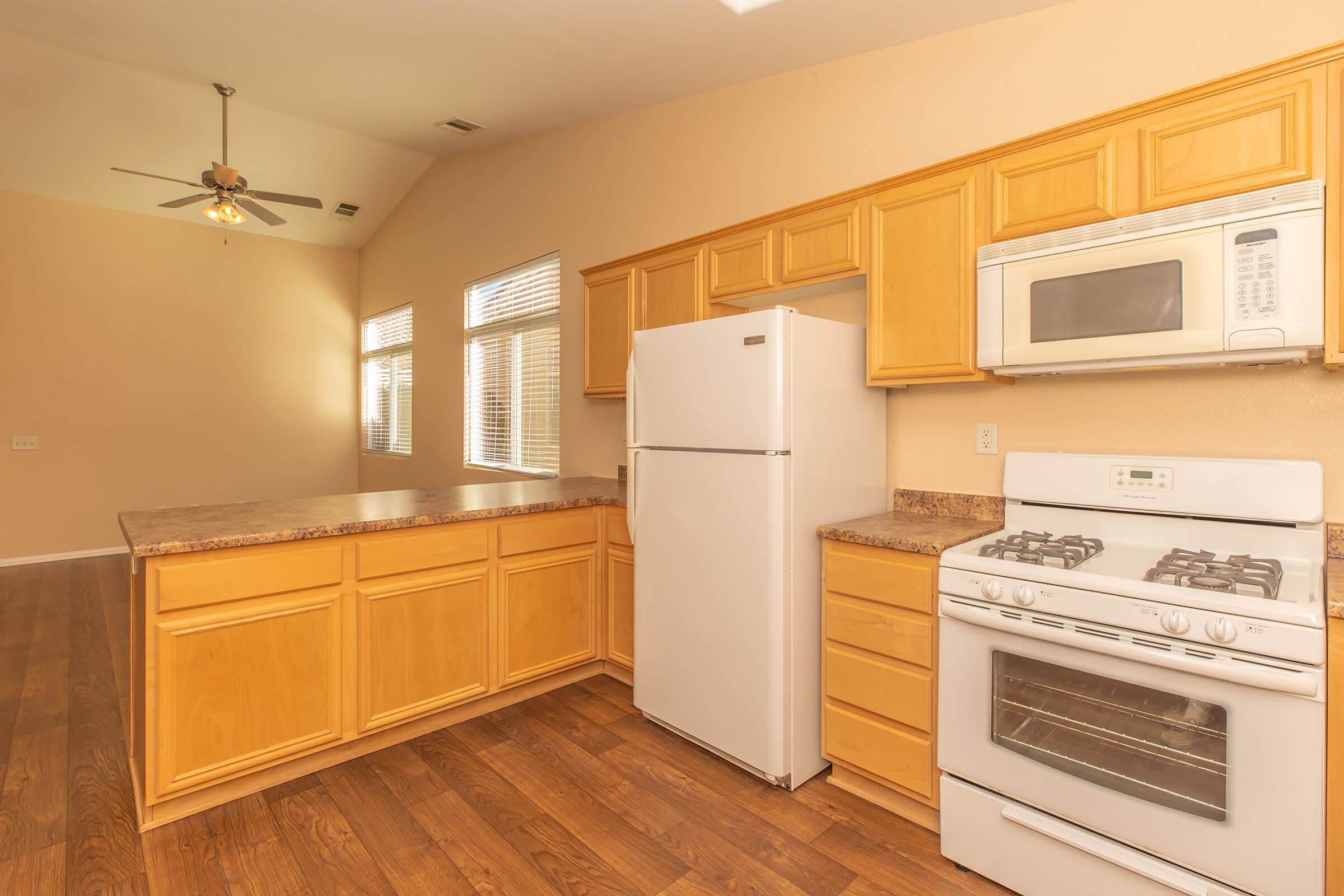 a kitchen with a stove and a refrigerator