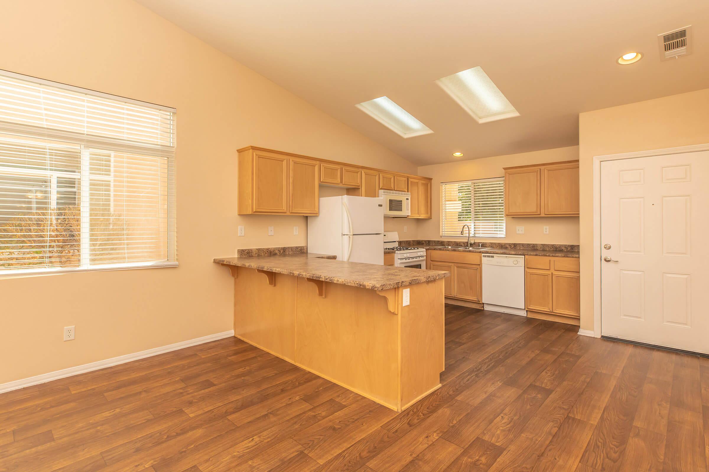 a kitchen with a wood floor