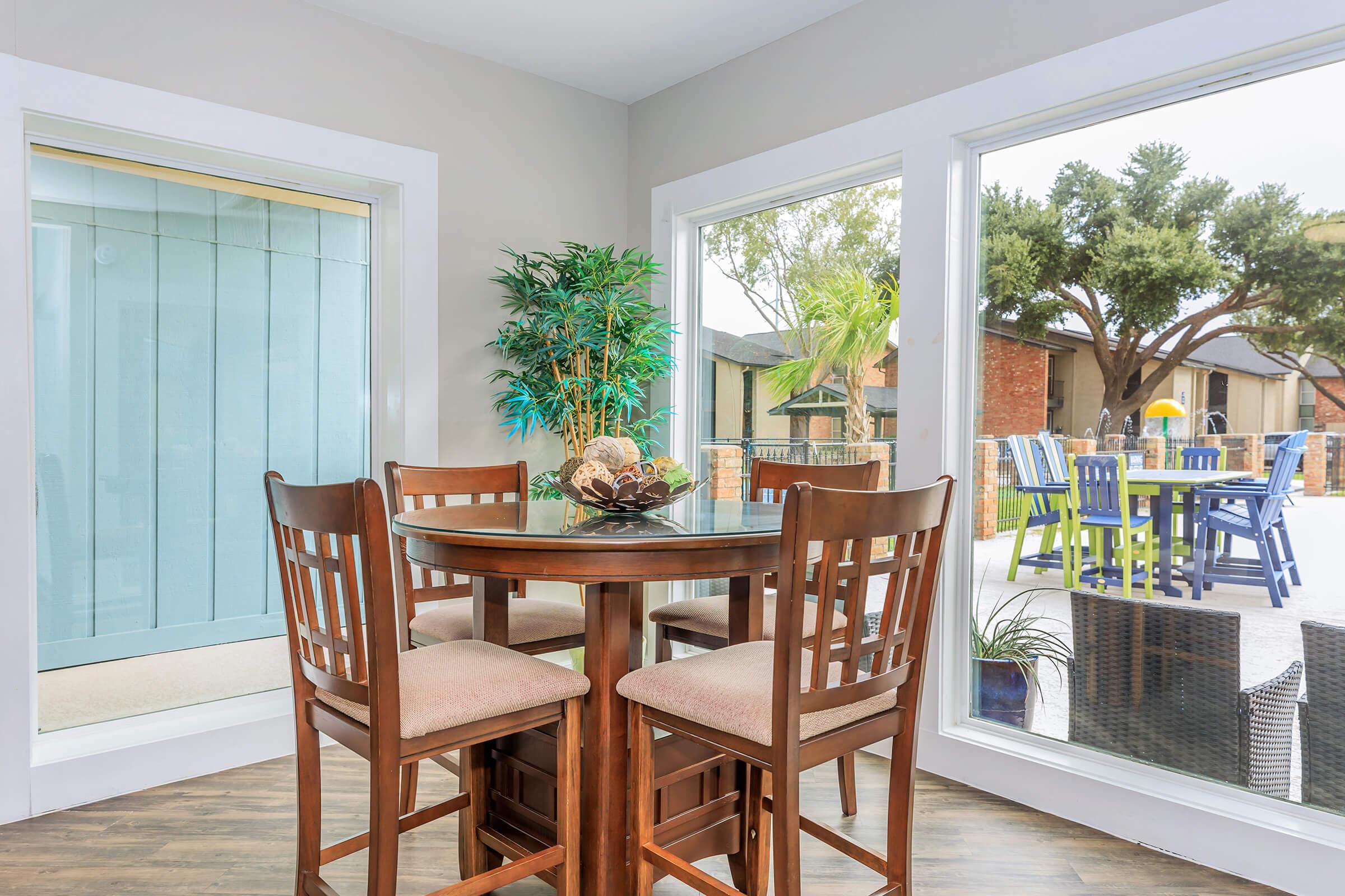 a dining room table in front of a window