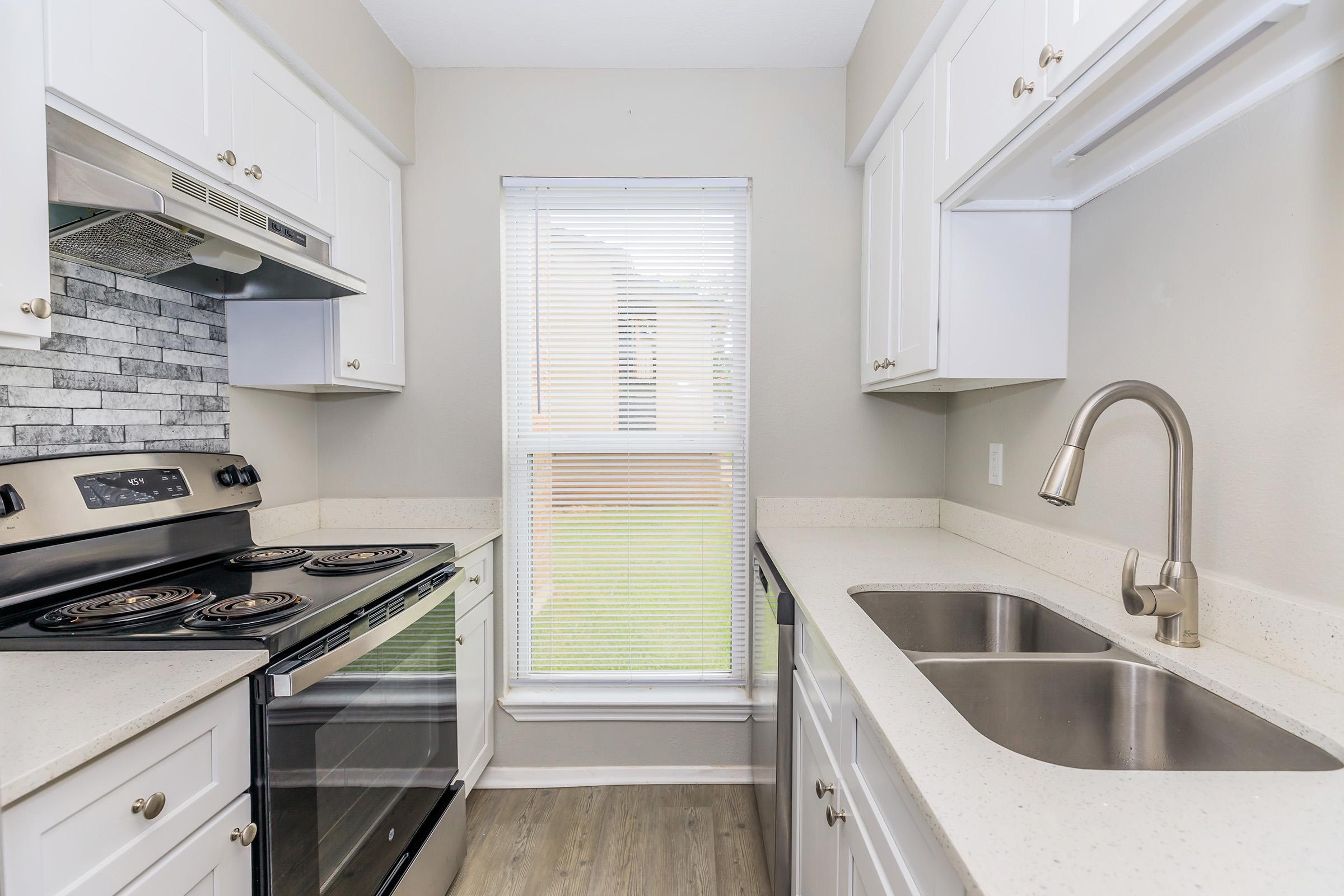 a stove top oven sitting inside of a kitchen