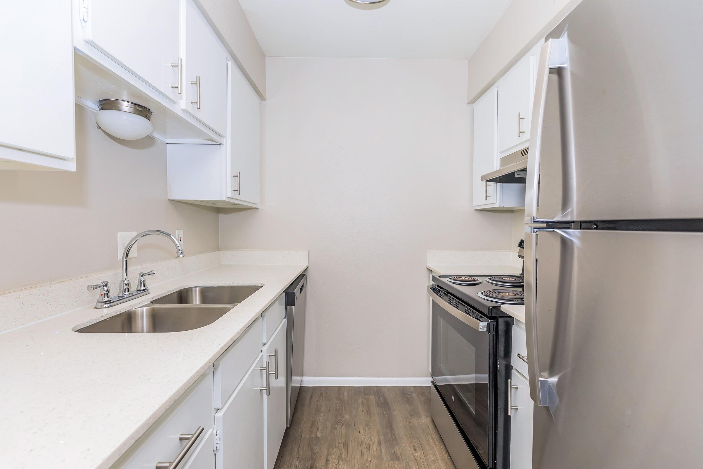 a kitchen with a sink and a refrigerator