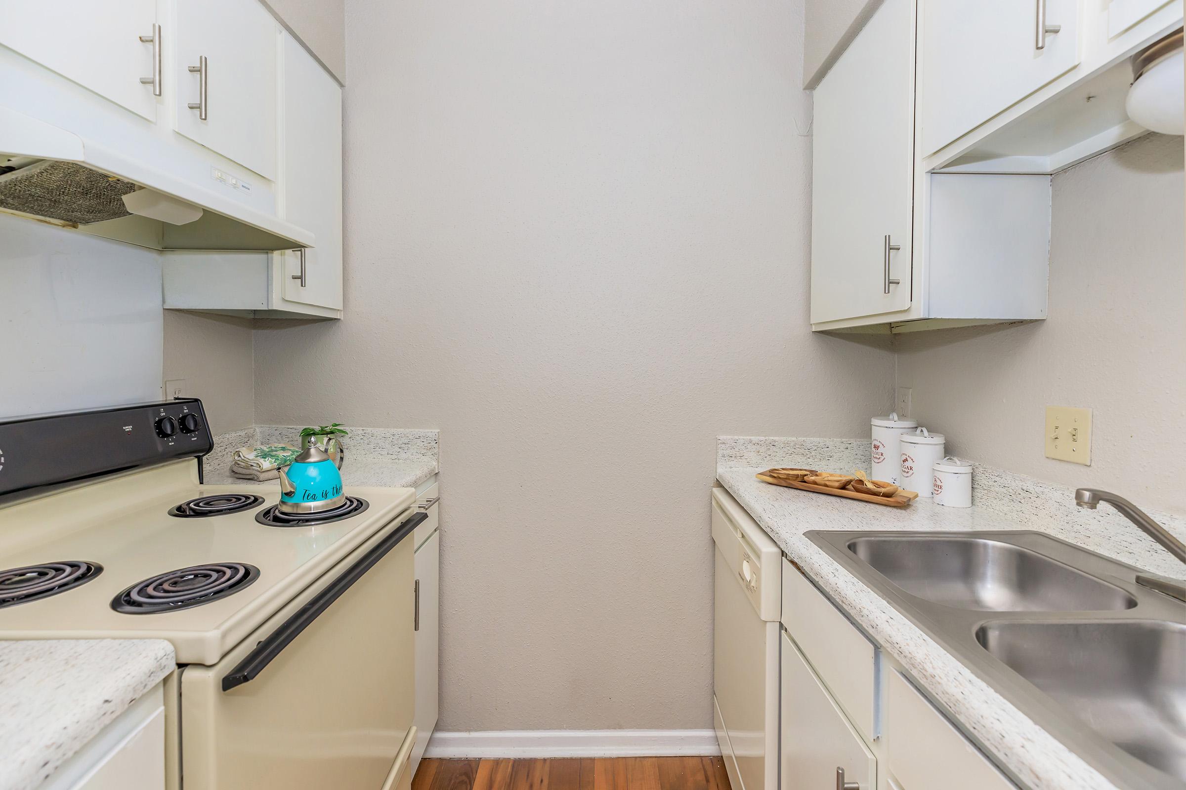 a kitchen with a stove and a sink