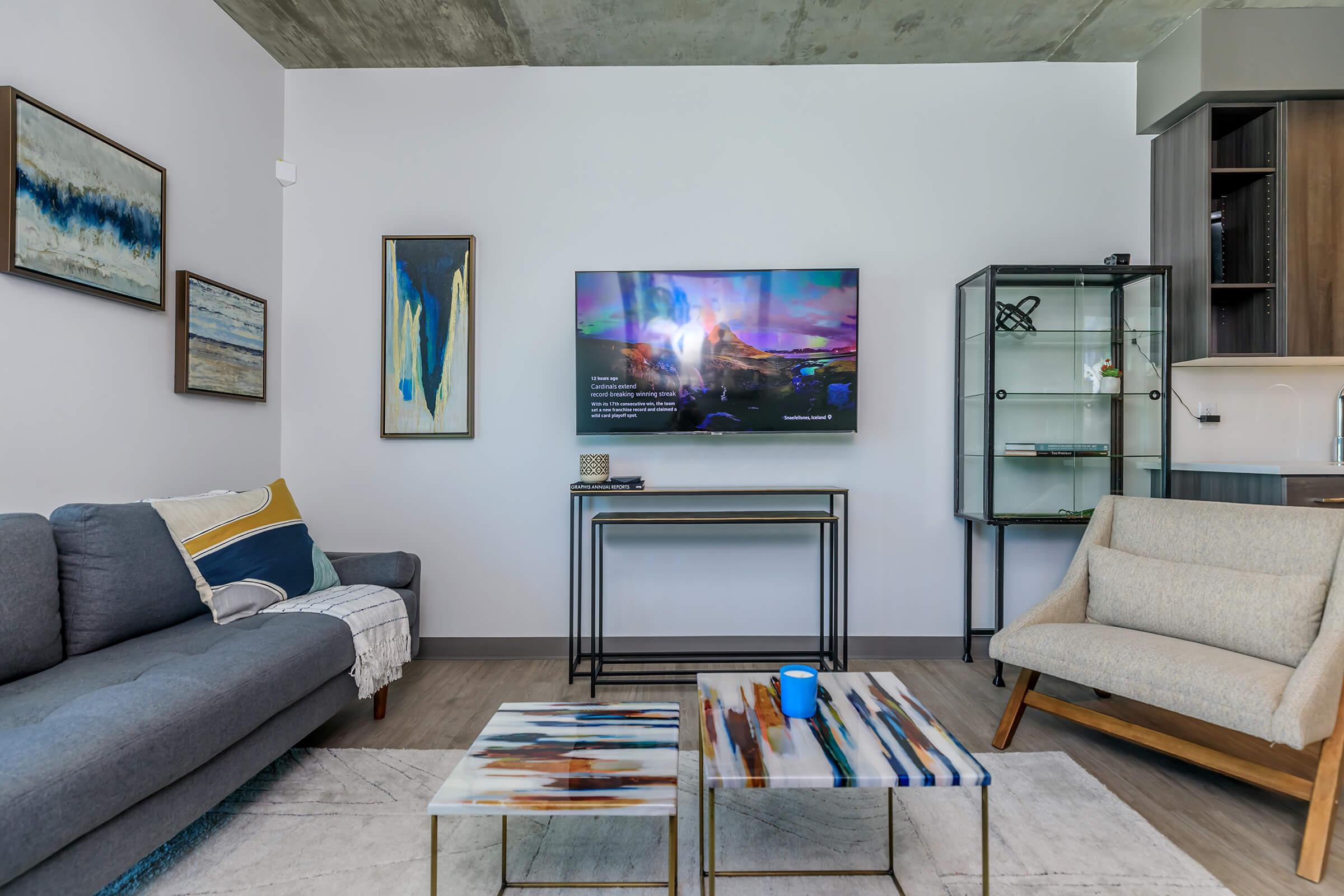 a living room filled with furniture and a flat screen tv