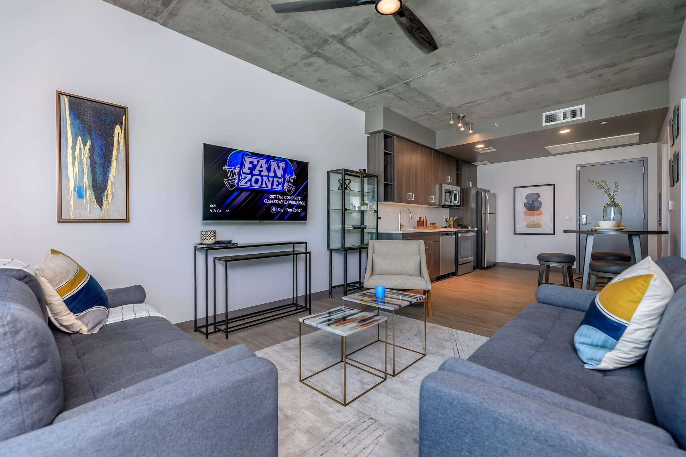 a living room filled with furniture and a flat screen tv