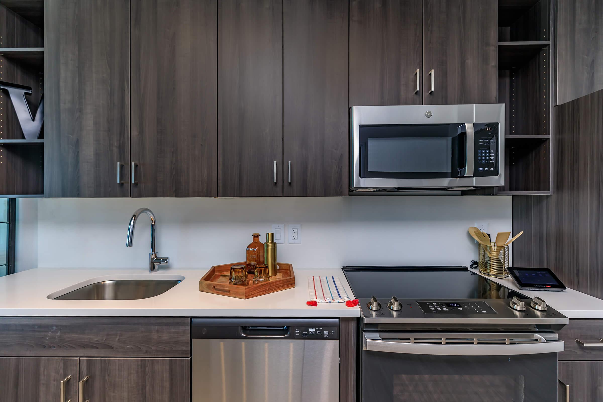 a kitchen with a stove a sink and a microwave