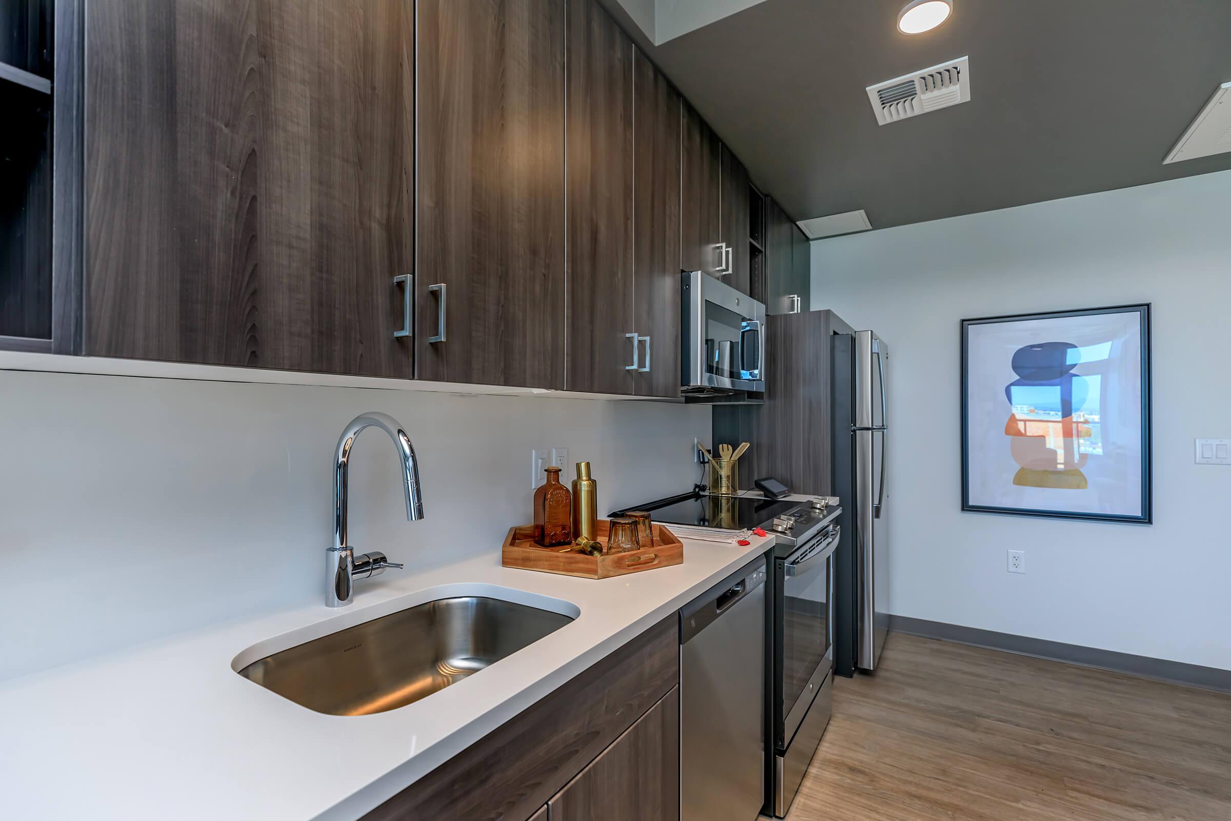 a modern kitchen with stainless steel appliances and wooden cabinets