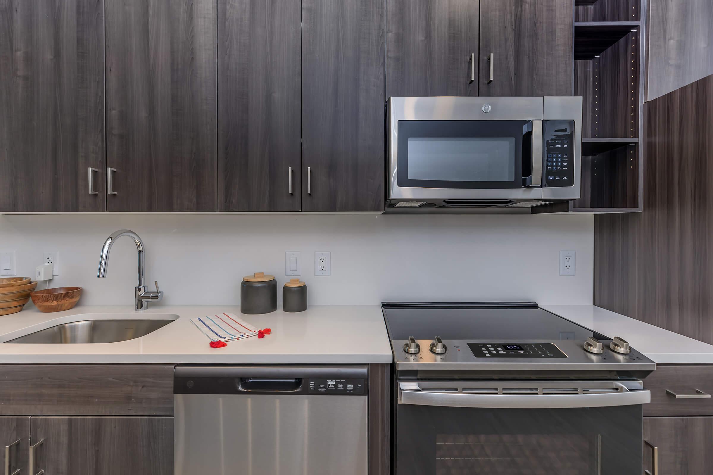 a kitchen with a stove a sink and a microwave