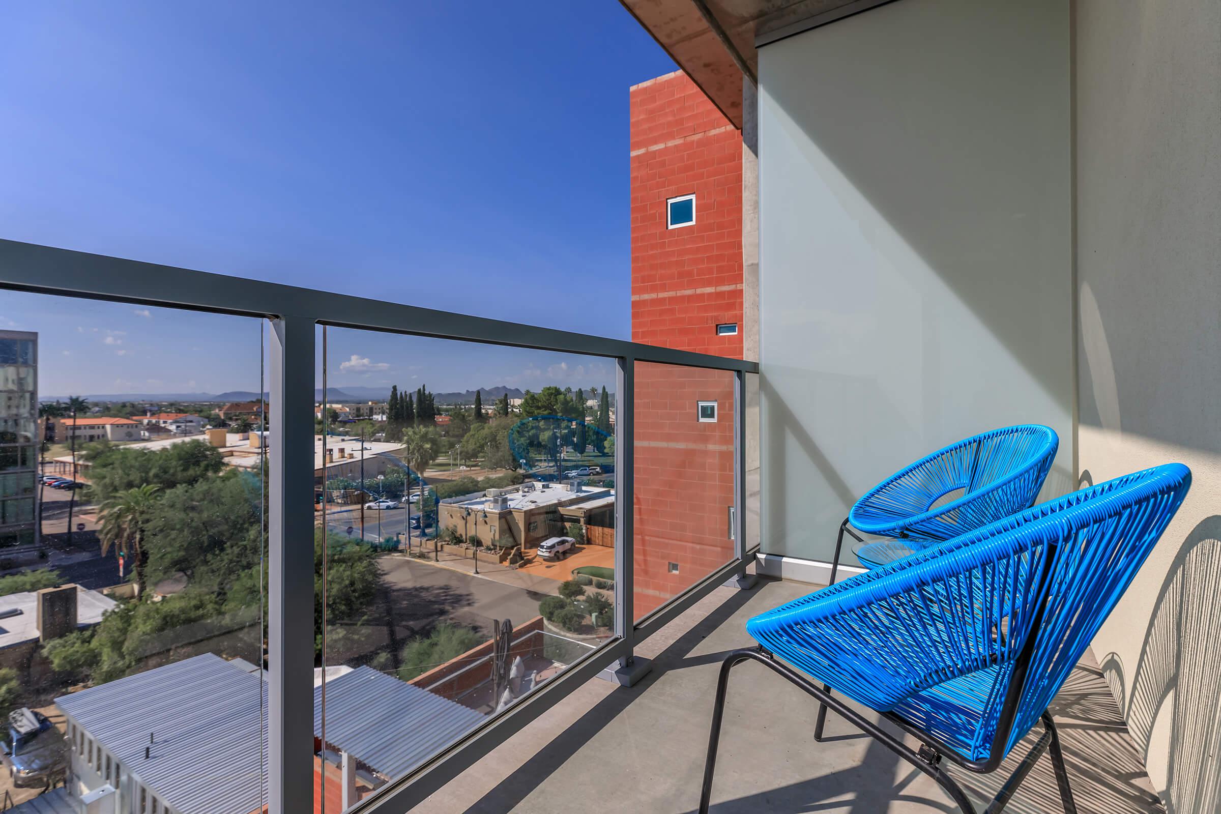 a blue bird sitting on top of a building