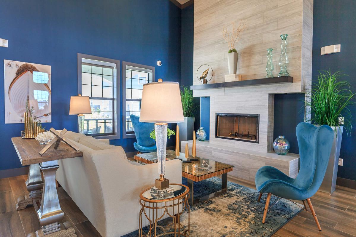 a living room filled with furniture and a fire place sitting in a chair