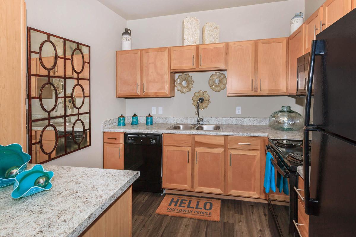 a modern kitchen with stainless steel appliances and wooden cabinets