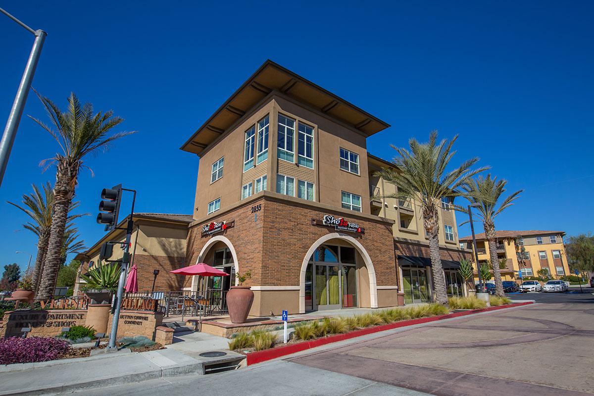 La Verne Village Luxury Apartment Homes & Shops building with table and red umbrella