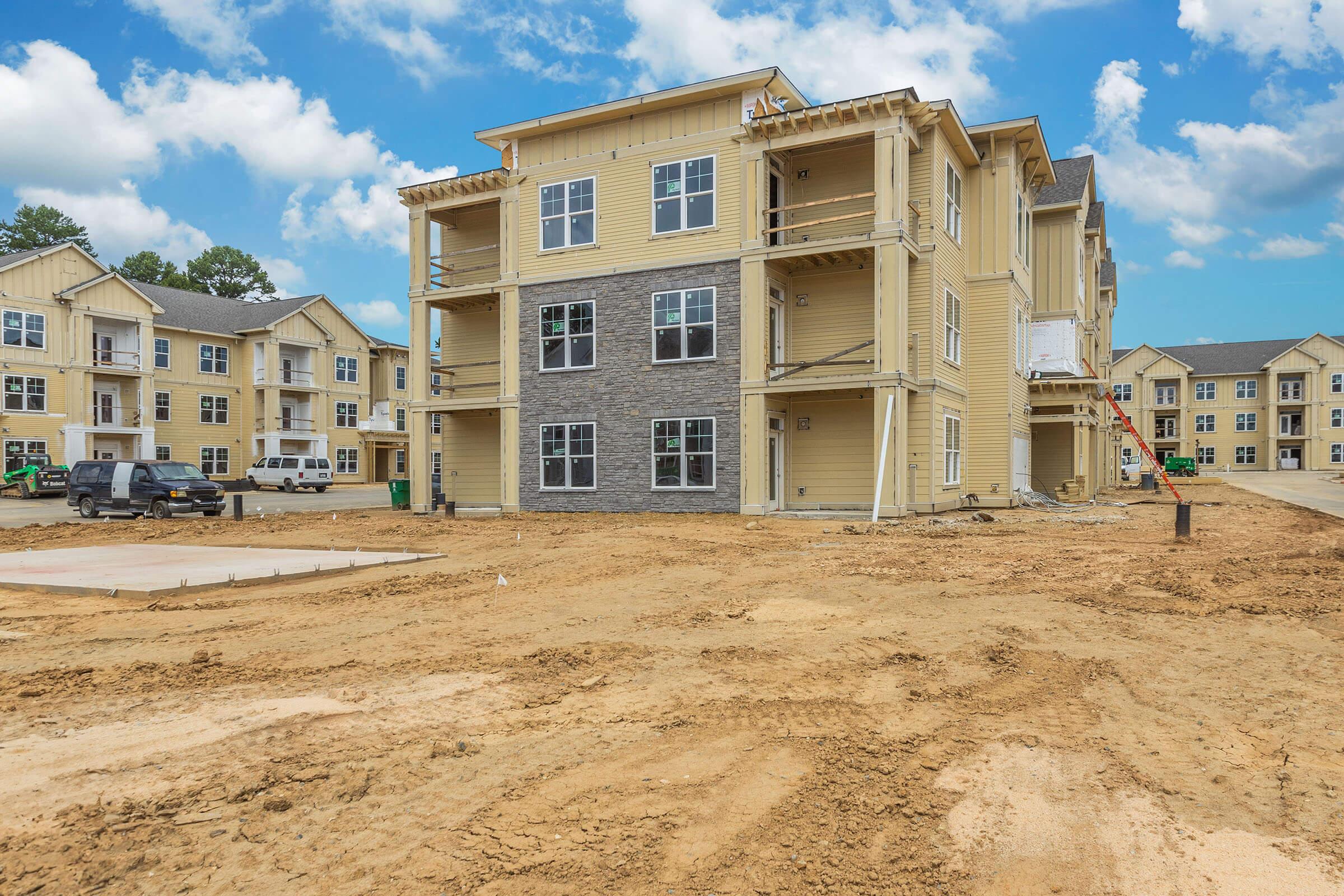 a dirt road in front of a building