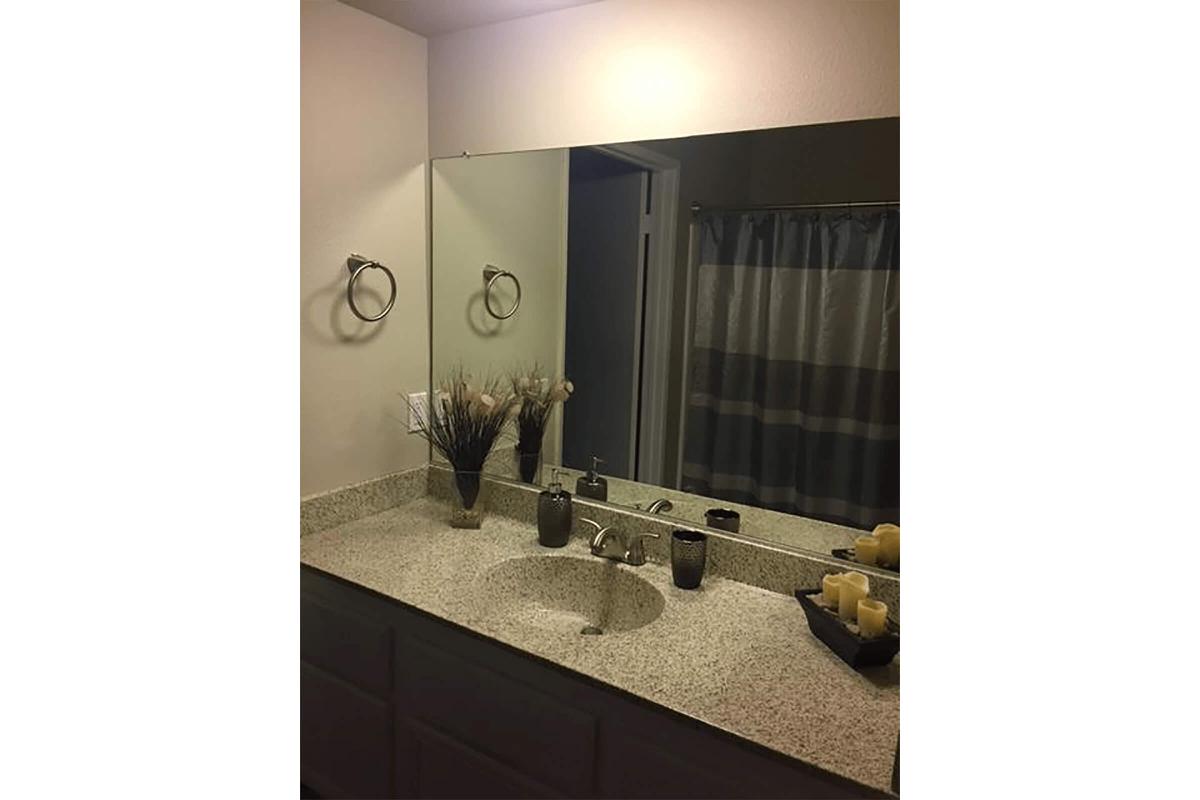 Furnished bathroom with a mirror
