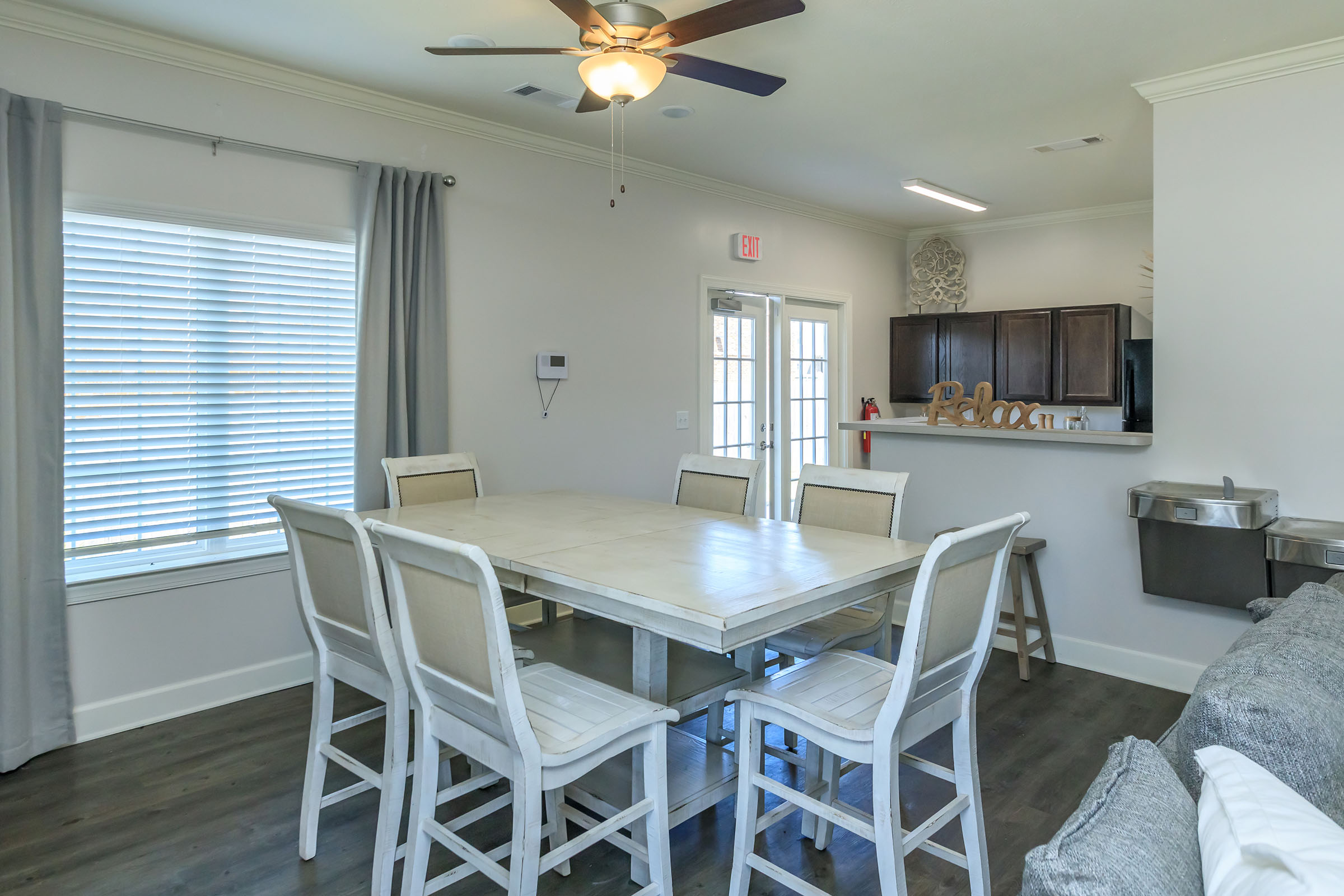 a dining room table in front of a window