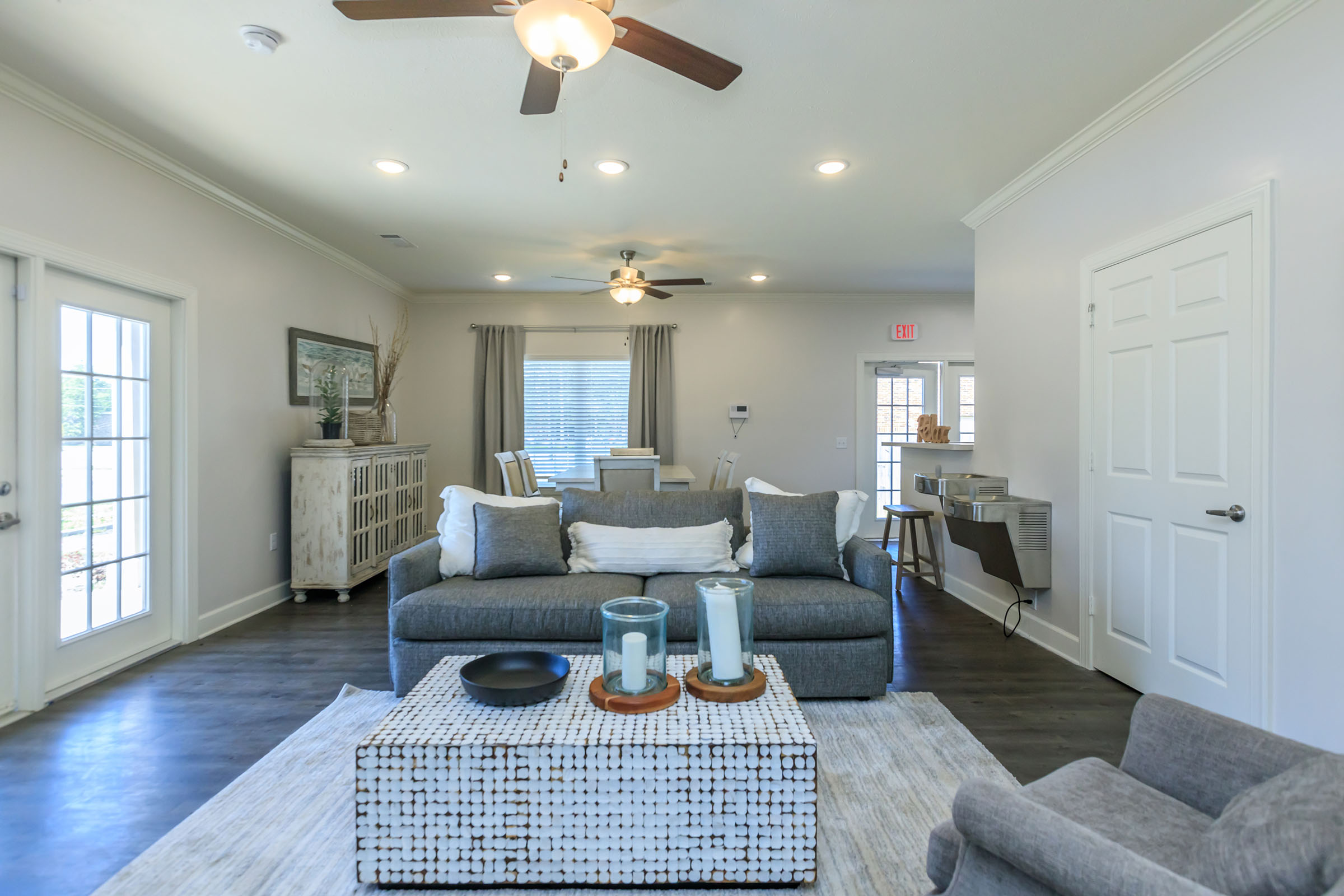 a living room filled with furniture and a large window