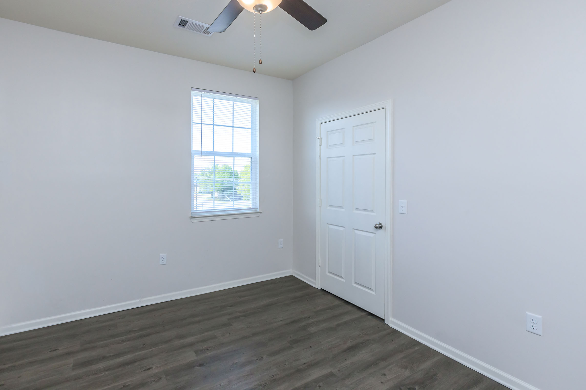 a large empty room with a wooden floor