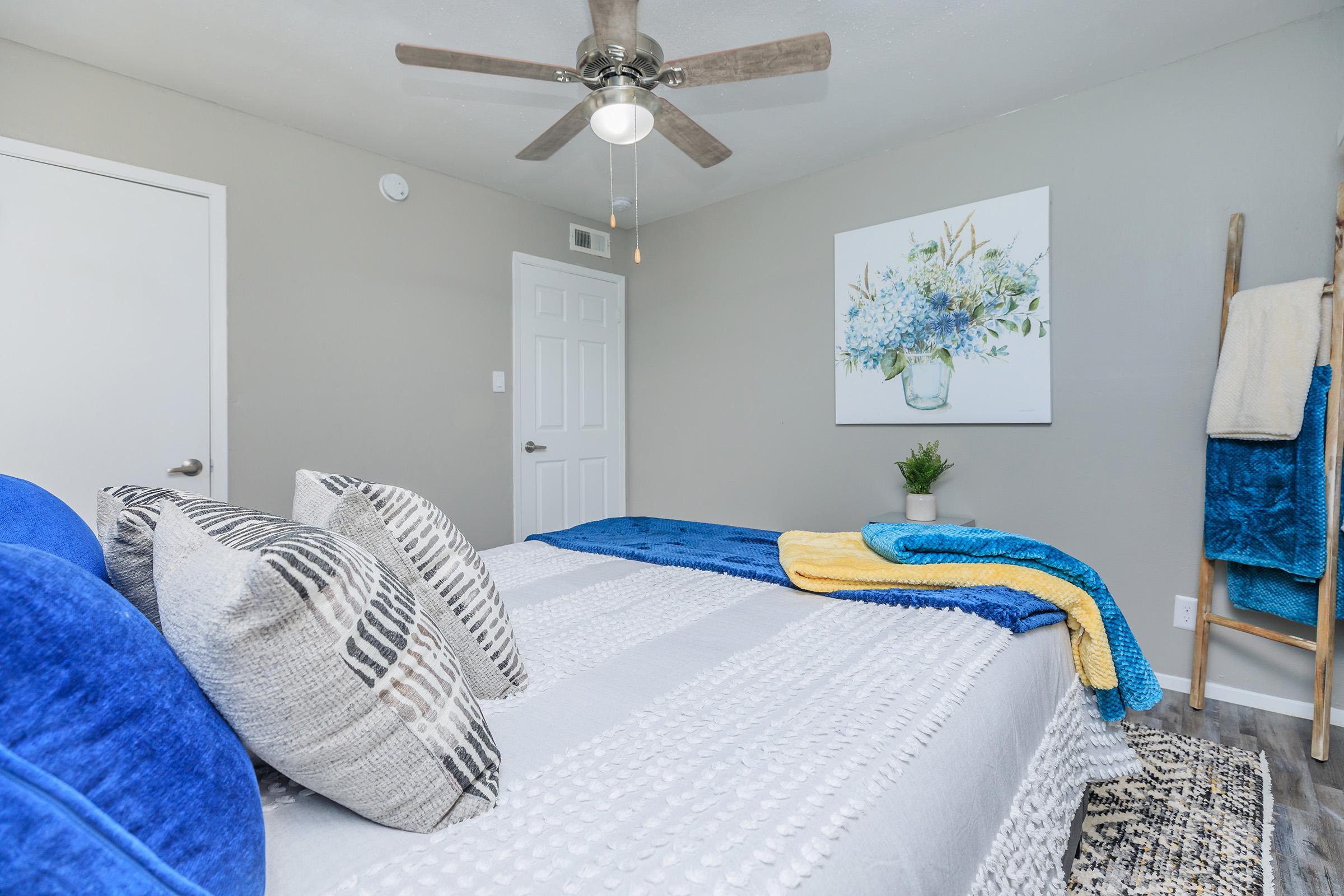 a bedroom with a blue blanket