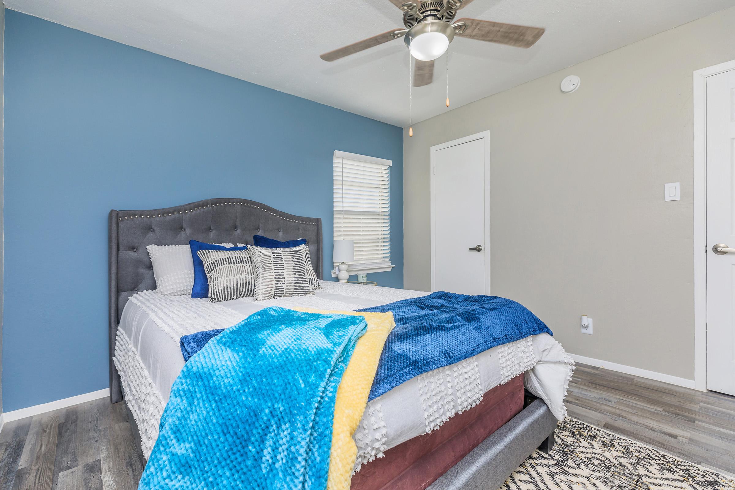 a bedroom with a blue blanket