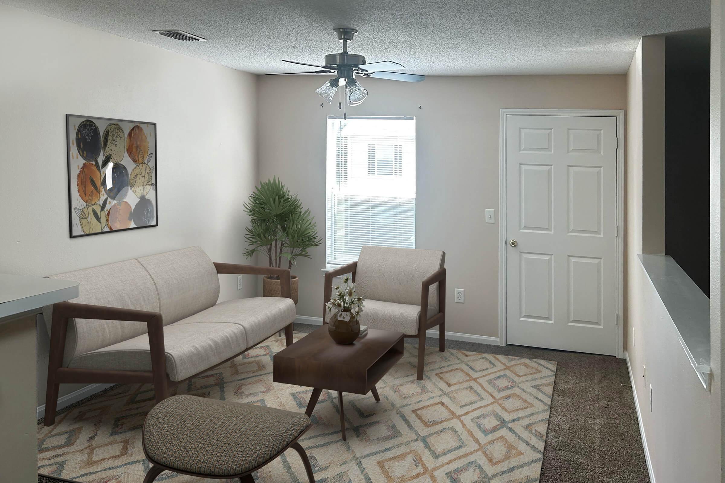 A modern living room featuring a light-colored sofa and two armchairs, a coffee table in the center, and a decorative plant in the corner. The room has a ceiling fan, a window with natural light, and a neutral-colored wall with abstract artwork. The floor is covered with a patterned rug.