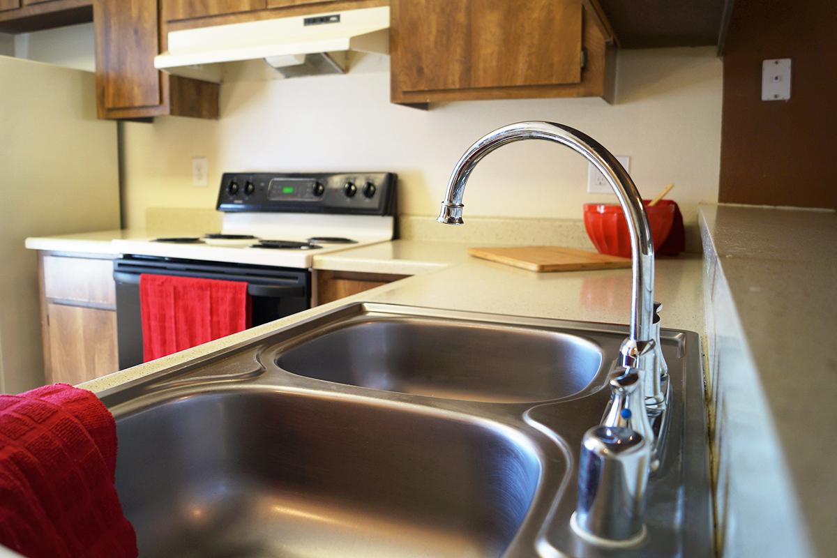 a stove top oven sitting inside of a kitchen