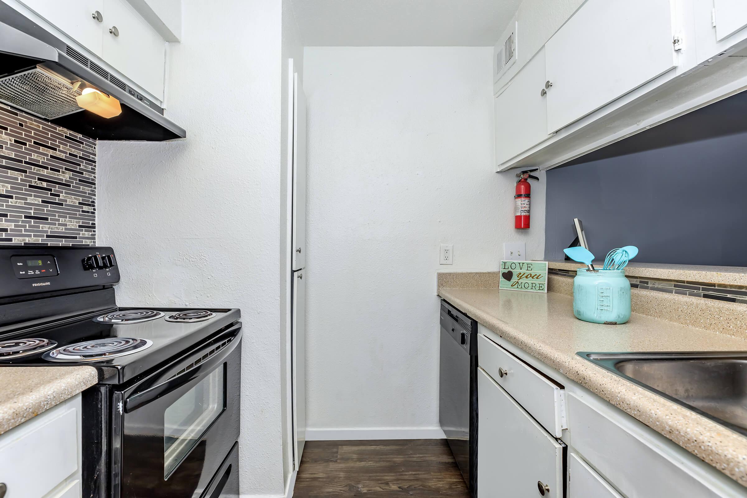 a stove top oven sitting inside of a kitchen