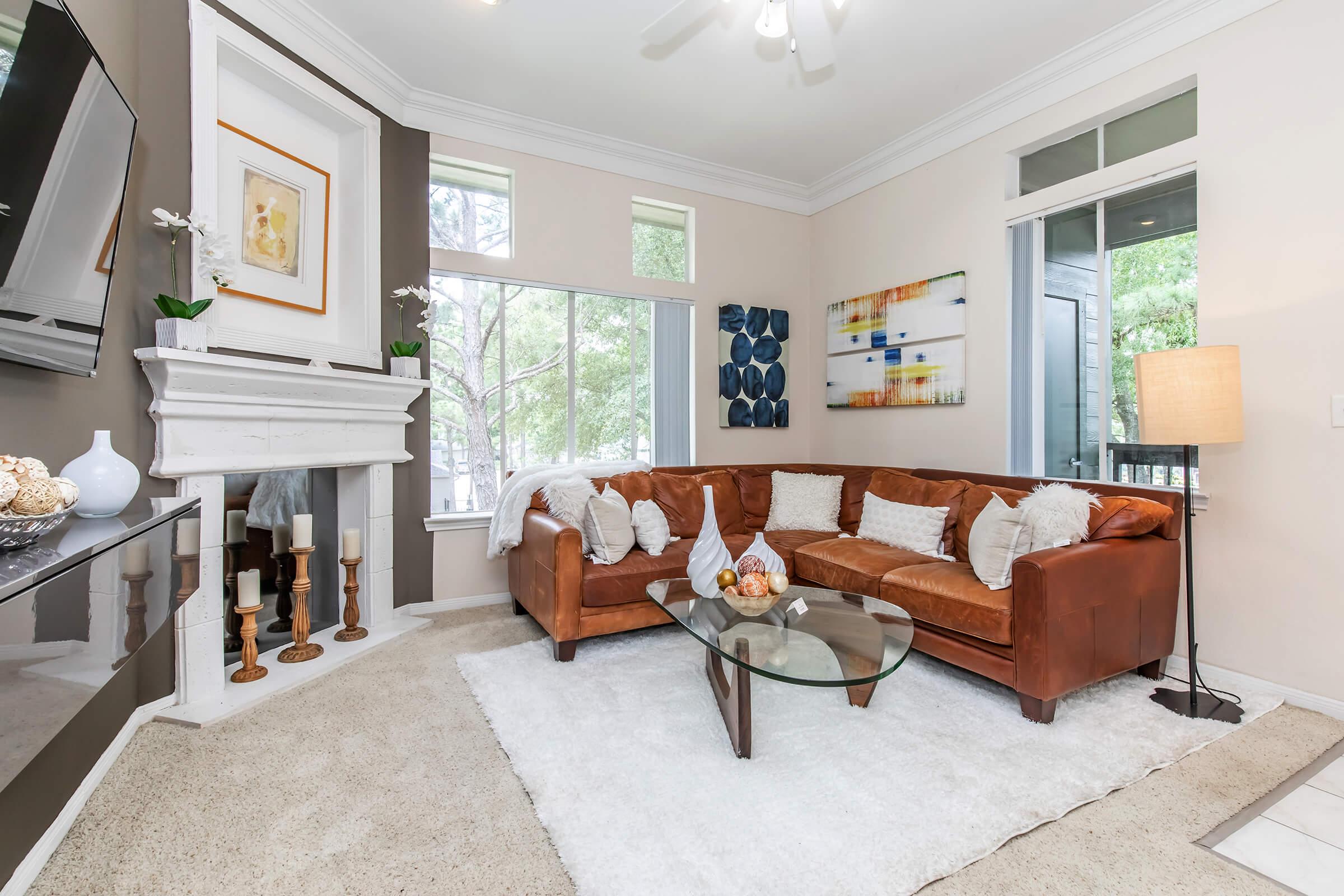 a living room filled with furniture and a large window