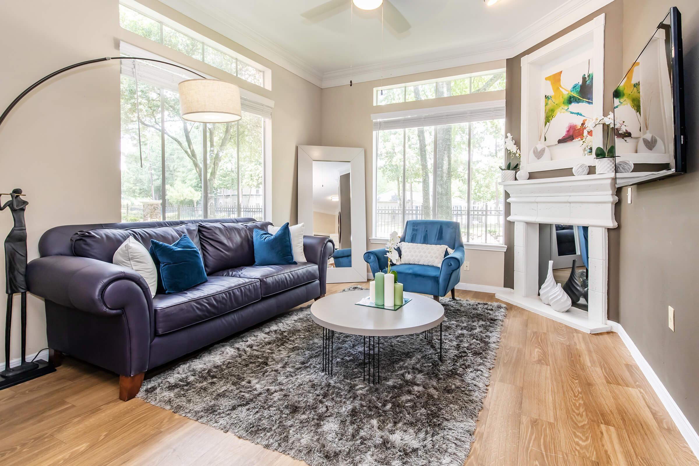 a living room filled with furniture and a large window