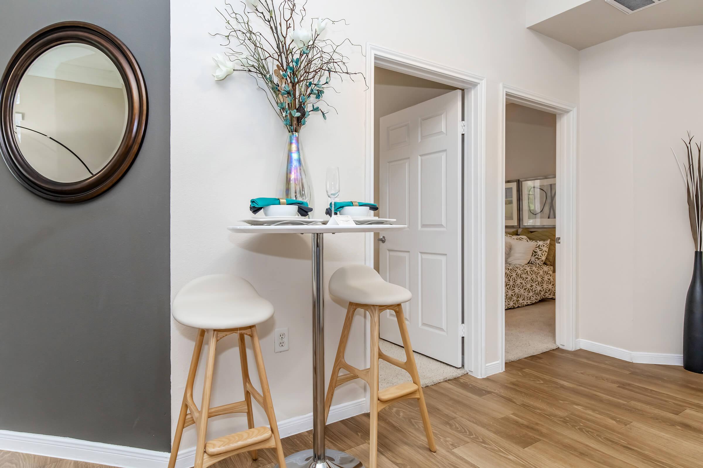 a chair sitting in front of a mirror