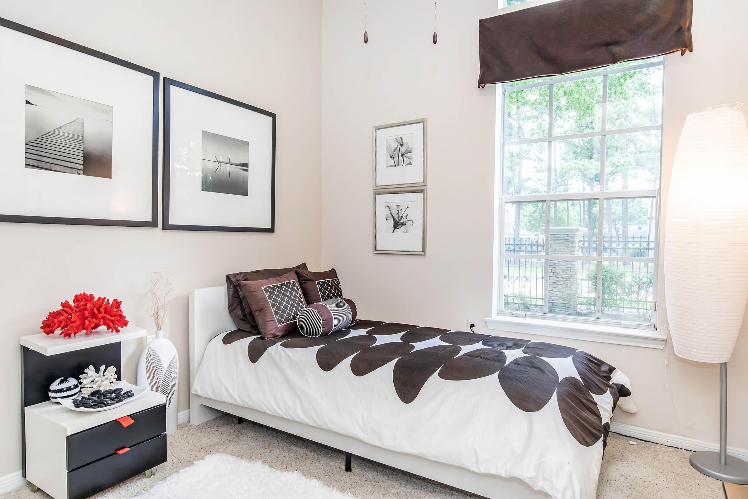 a bedroom with a large window