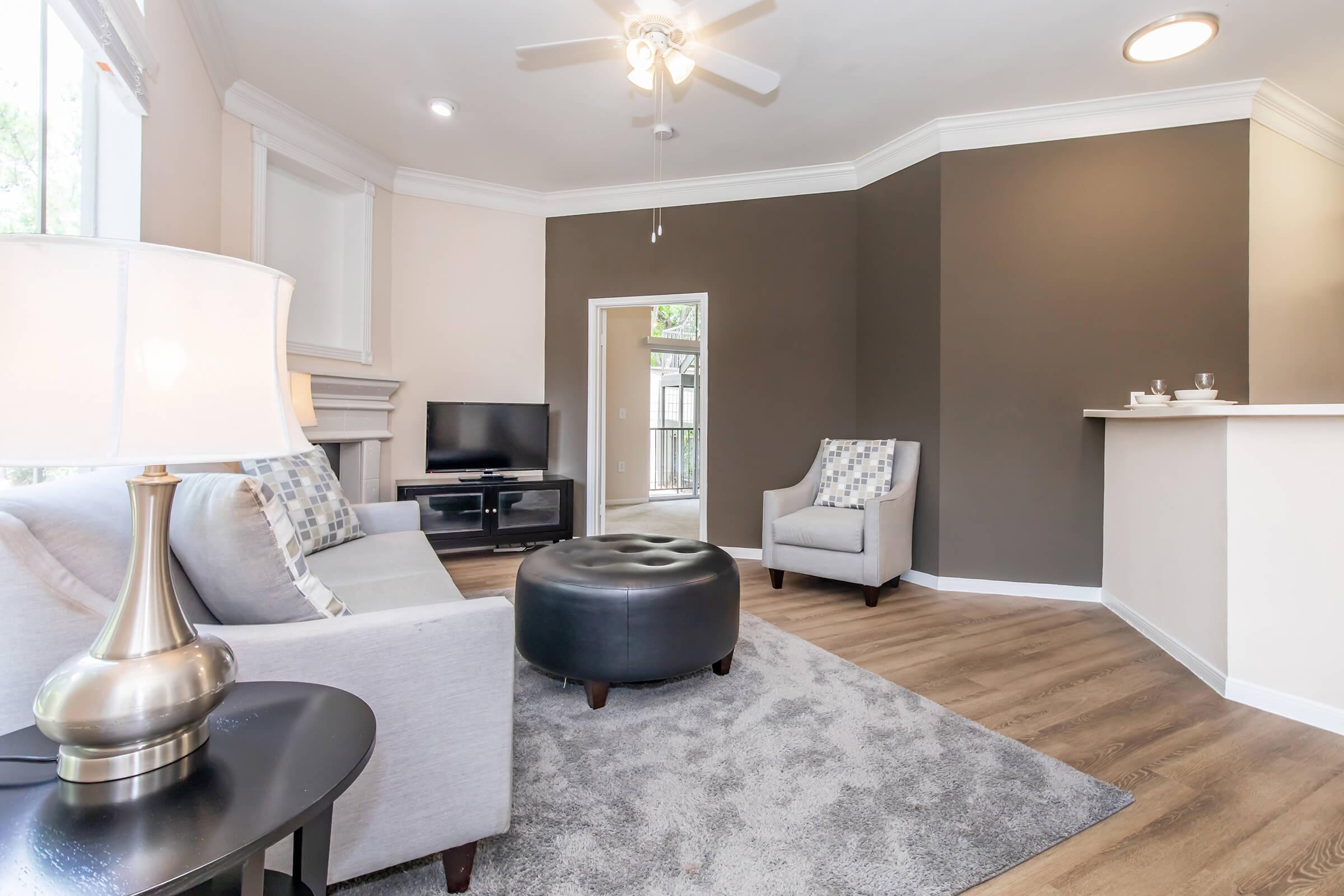 a living room filled with furniture and vase on a table